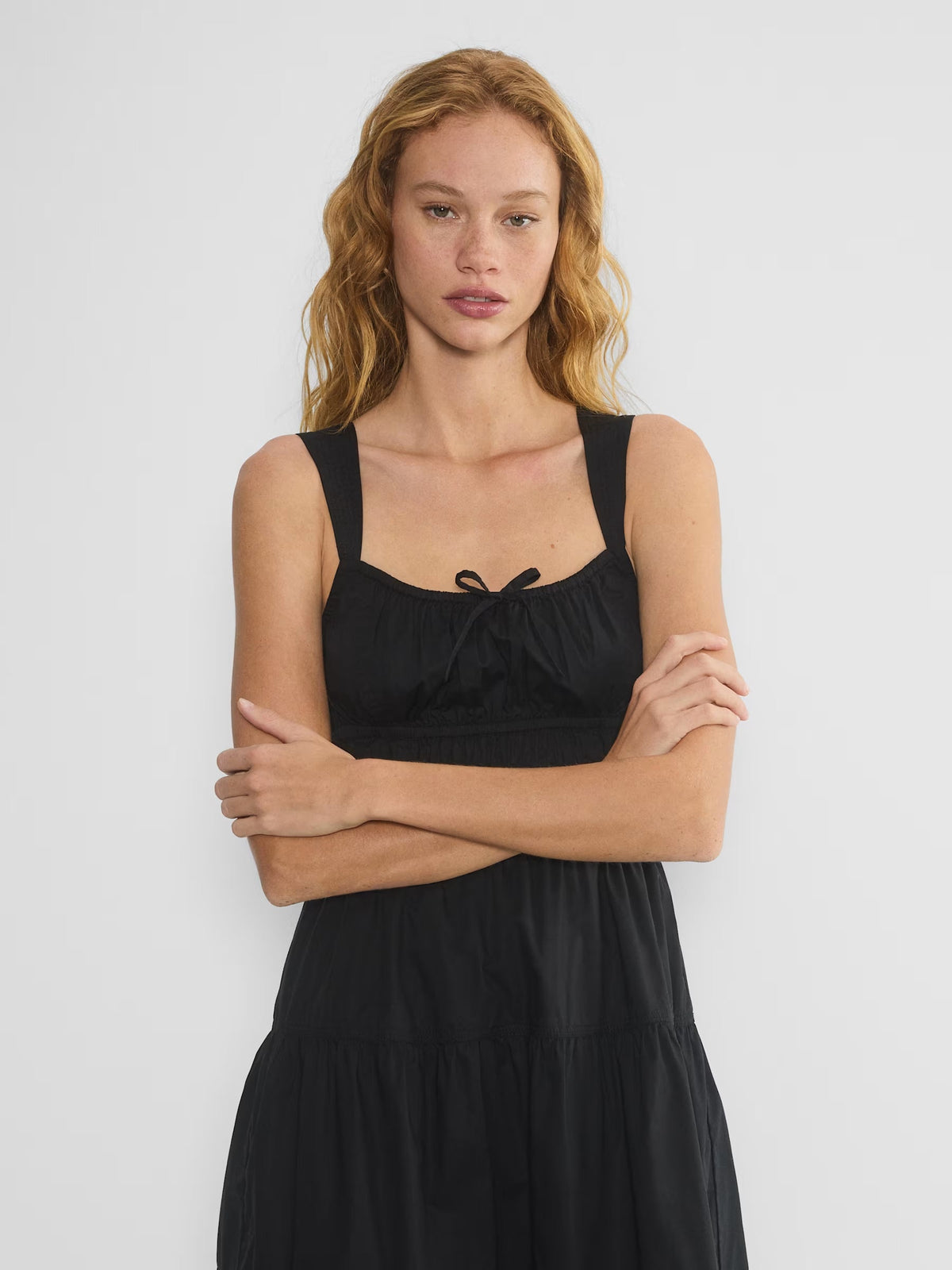 Black sleeveless tiered midi dress, square neckline with bow spaghetti straps and smocked bodice