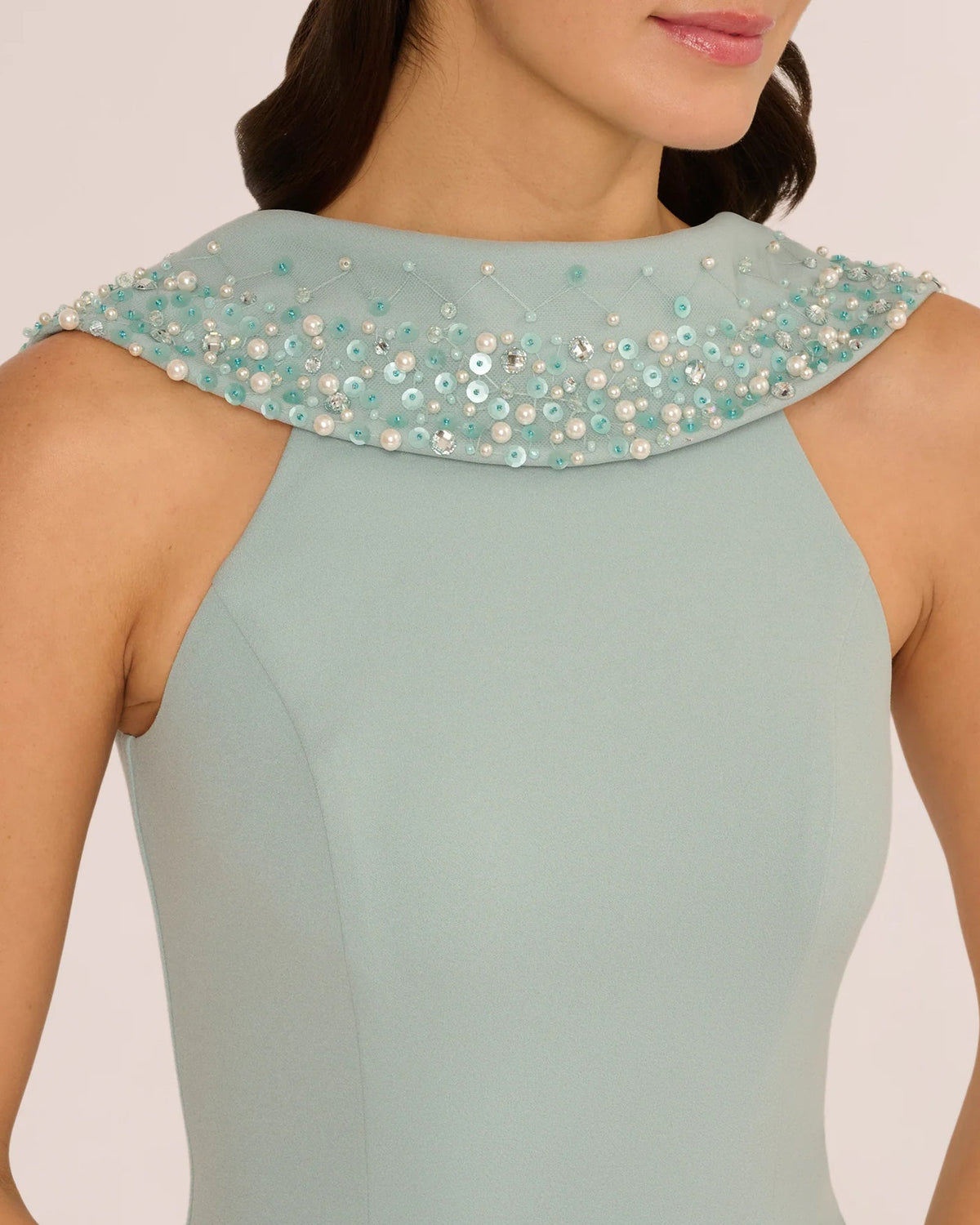 Pale aqua sleeveless sheath dress with embellished beaded neckline and shoulder trim.