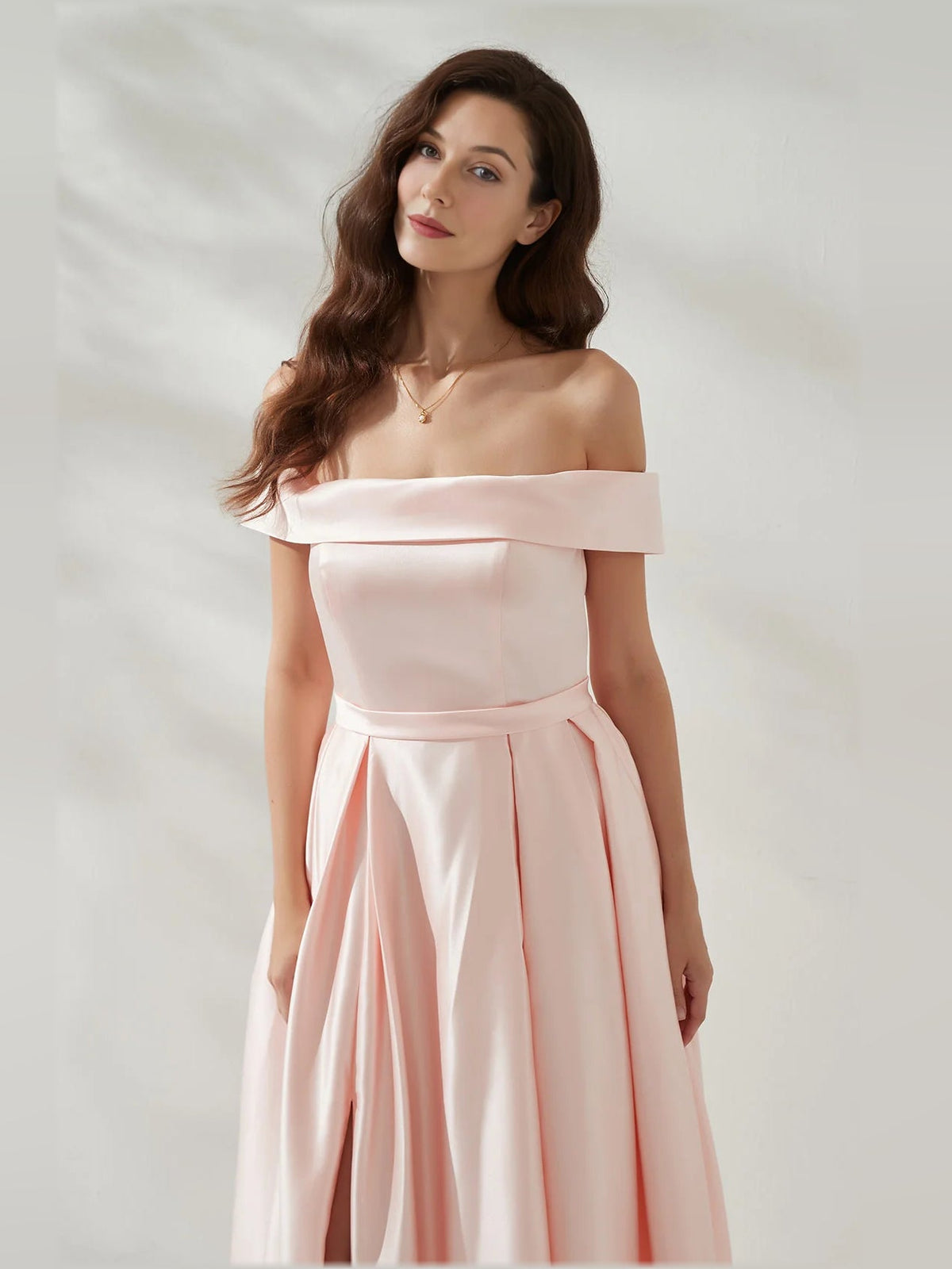 Peach off-shoulder formal dress with open back, pleated skirt and thigh slit, floor-length