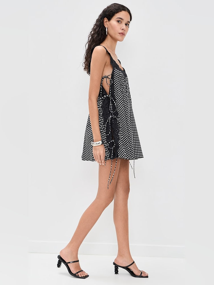 Black mini dress with white grid pattern, tie detail at open back, sleeveless