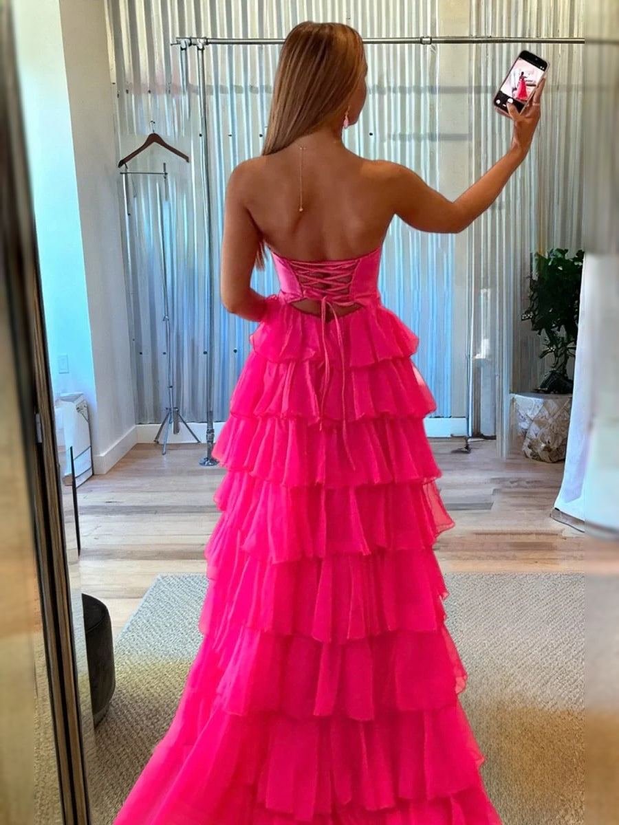 Back view of hot pink strapless sweetheart ruffle prom dress with corset cut-out detail