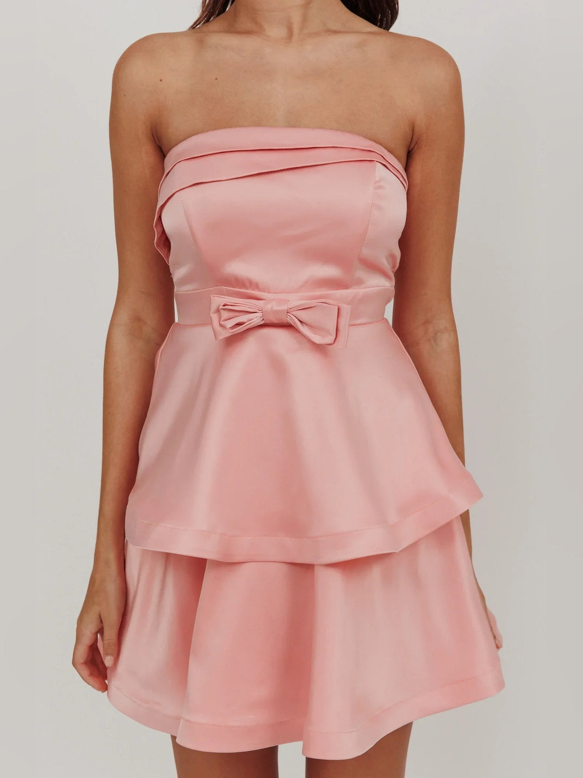 Pink strapless satin mini dress bodice with layered ruffles and bow waist