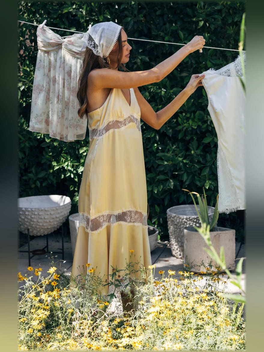 Yellow satin slip midi dress with lace trim, flowing skirt, open-back detail