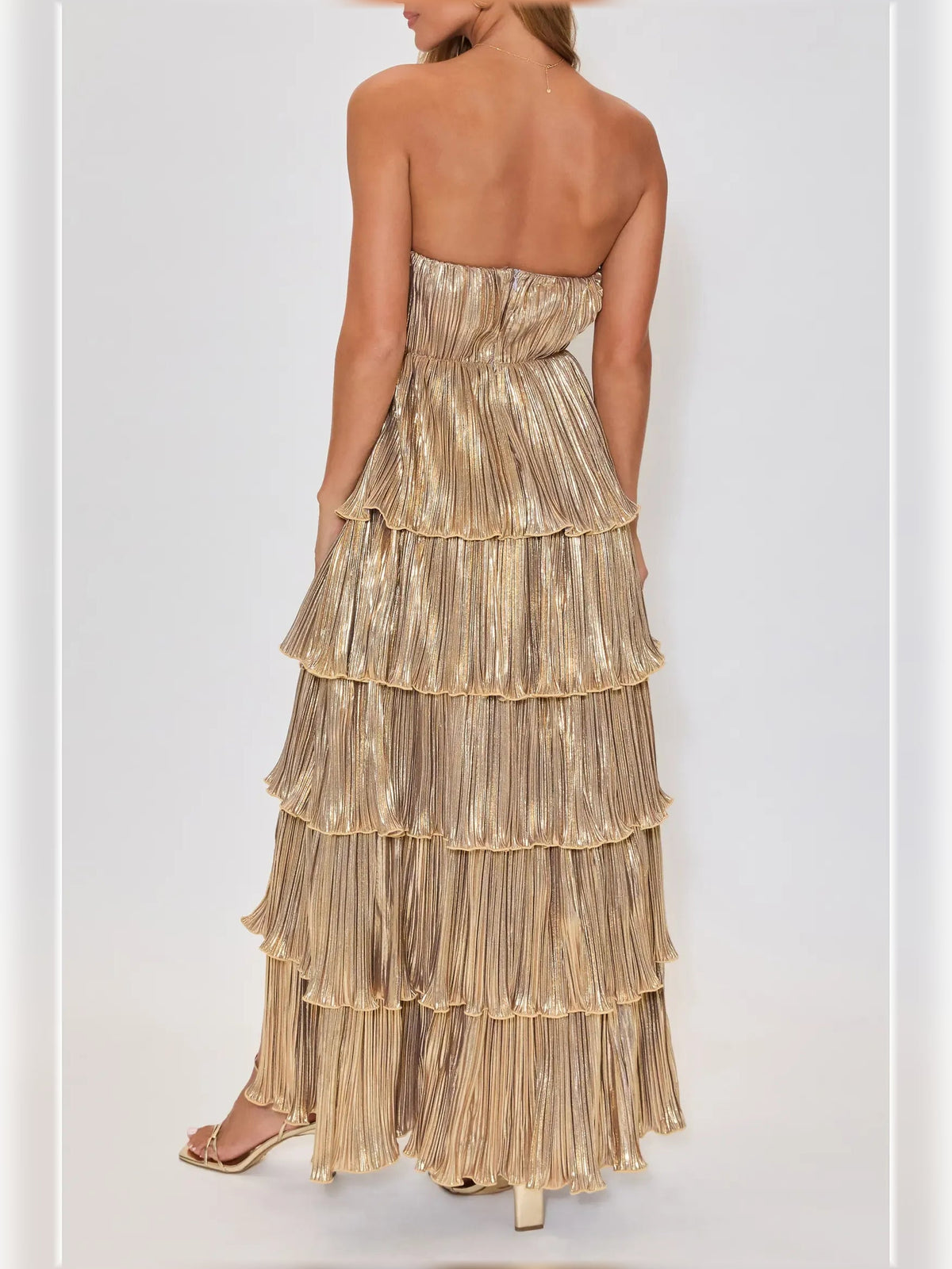 Gold strapless tiered formal dress with open back and layered ruffle skirt
