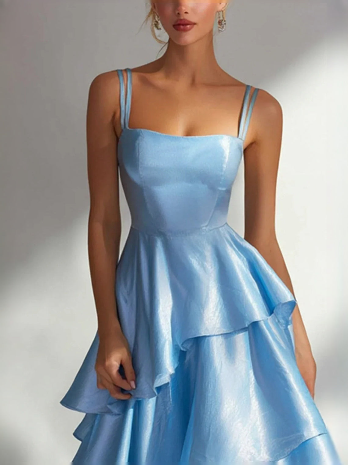 Light blue satin prom dress, square neckline with thin straps and tiered ruffle skirt detail.