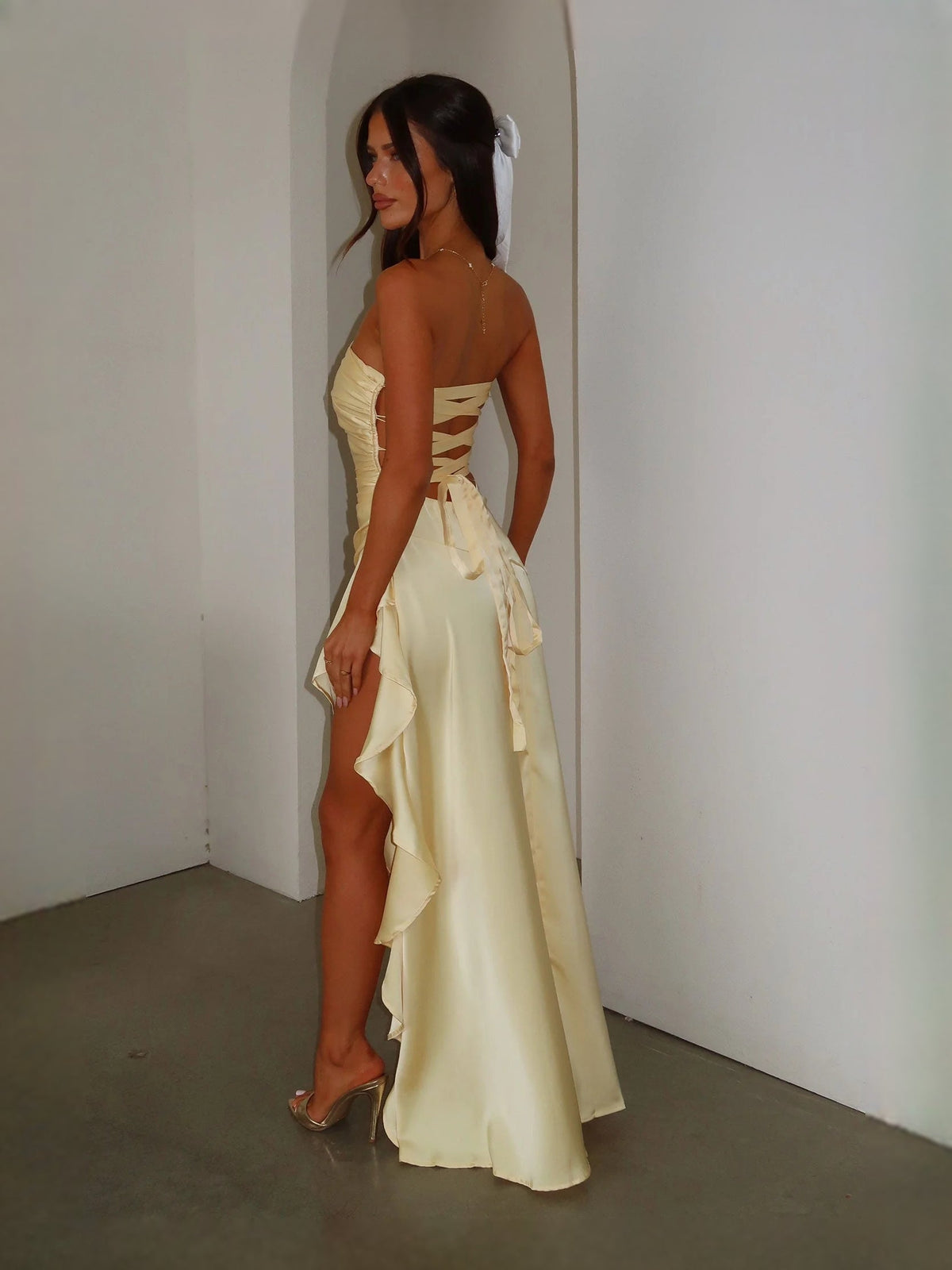Strapless satin prom dress with ruched back and ruffled drape, pale yellow A-line