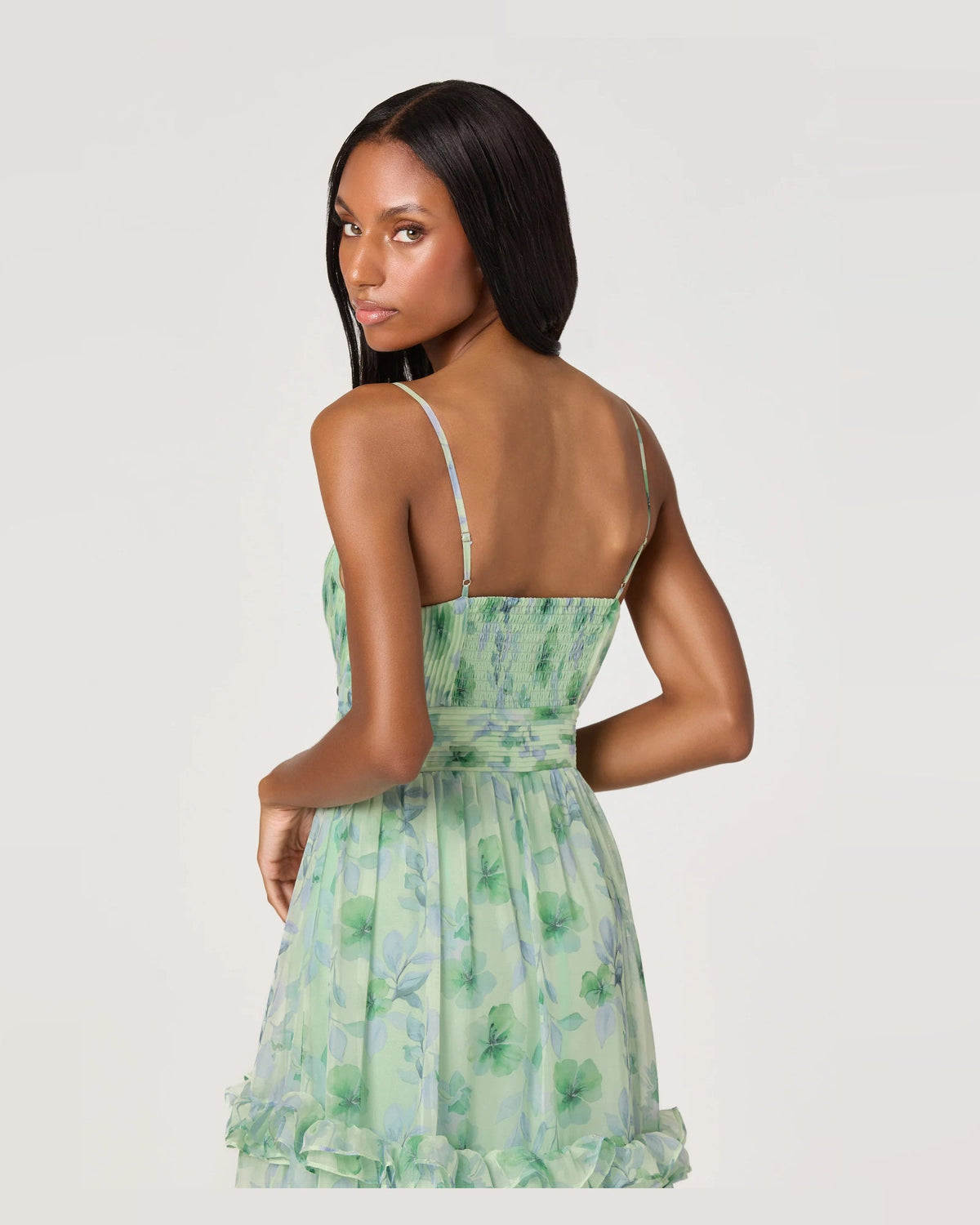 Green floral open-back maxi dress with spaghetti straps and tiered ruffle skirt