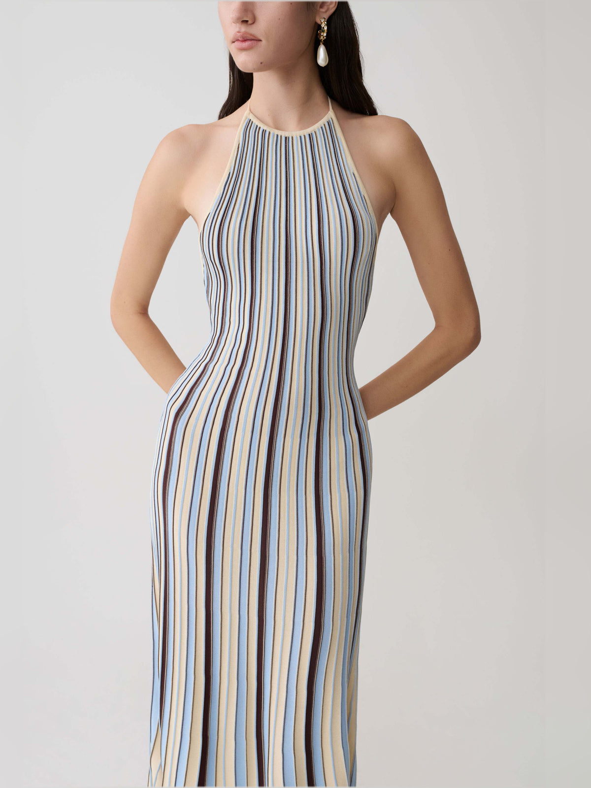 Halterneck knit midi dress close-up with vertical cream, blue, and brown stripes.