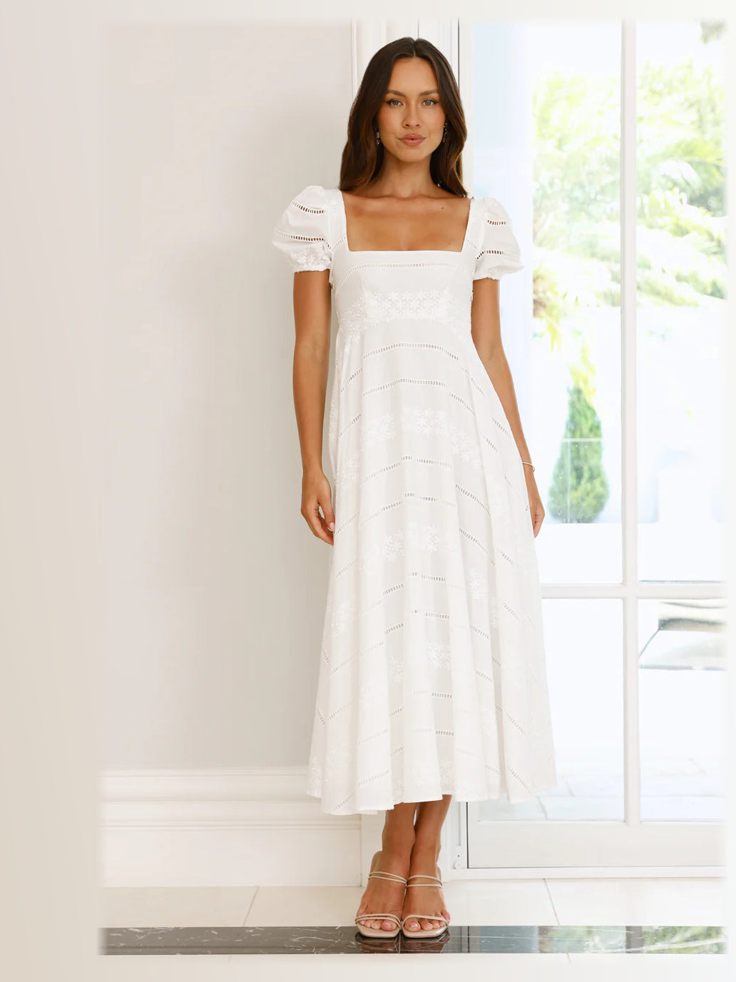 White formal dress with structured woven fabric construction and maxi hem