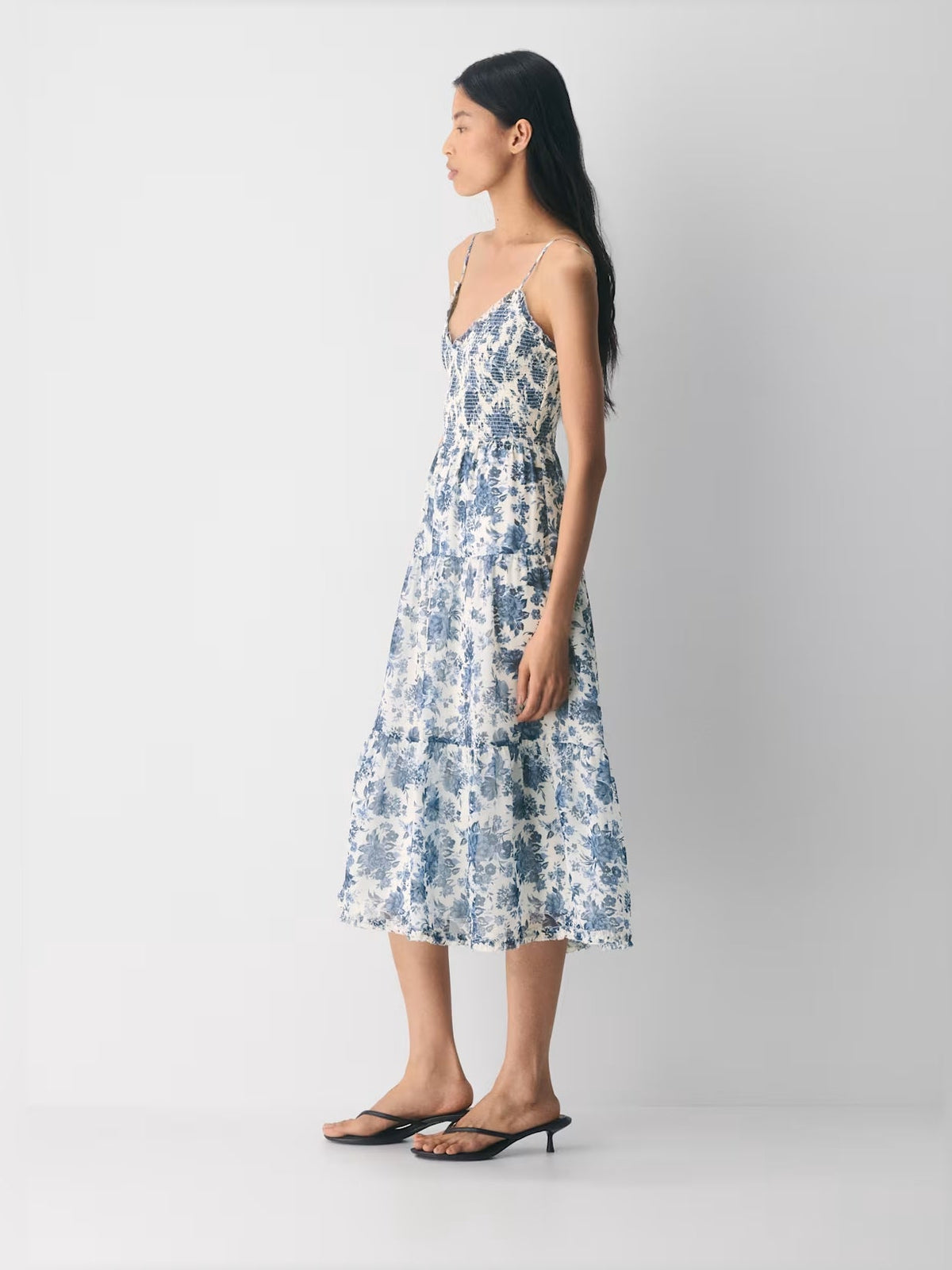 Blue floral tiered midi dress with V-neck and spaghetti straps, side view