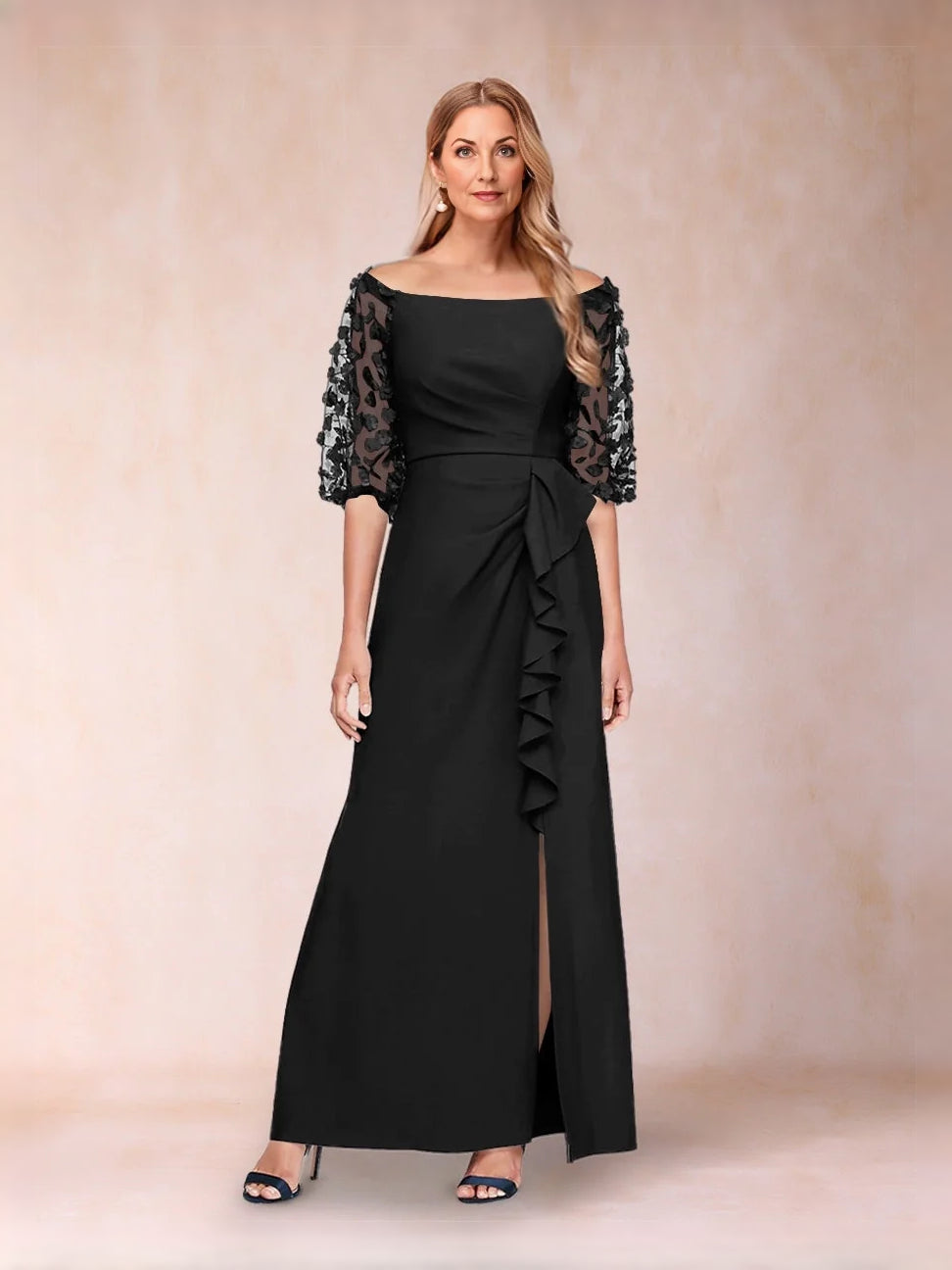 Off-shoulder black formal gown with lace sleeves and side-slit skirt with pleated ruffle