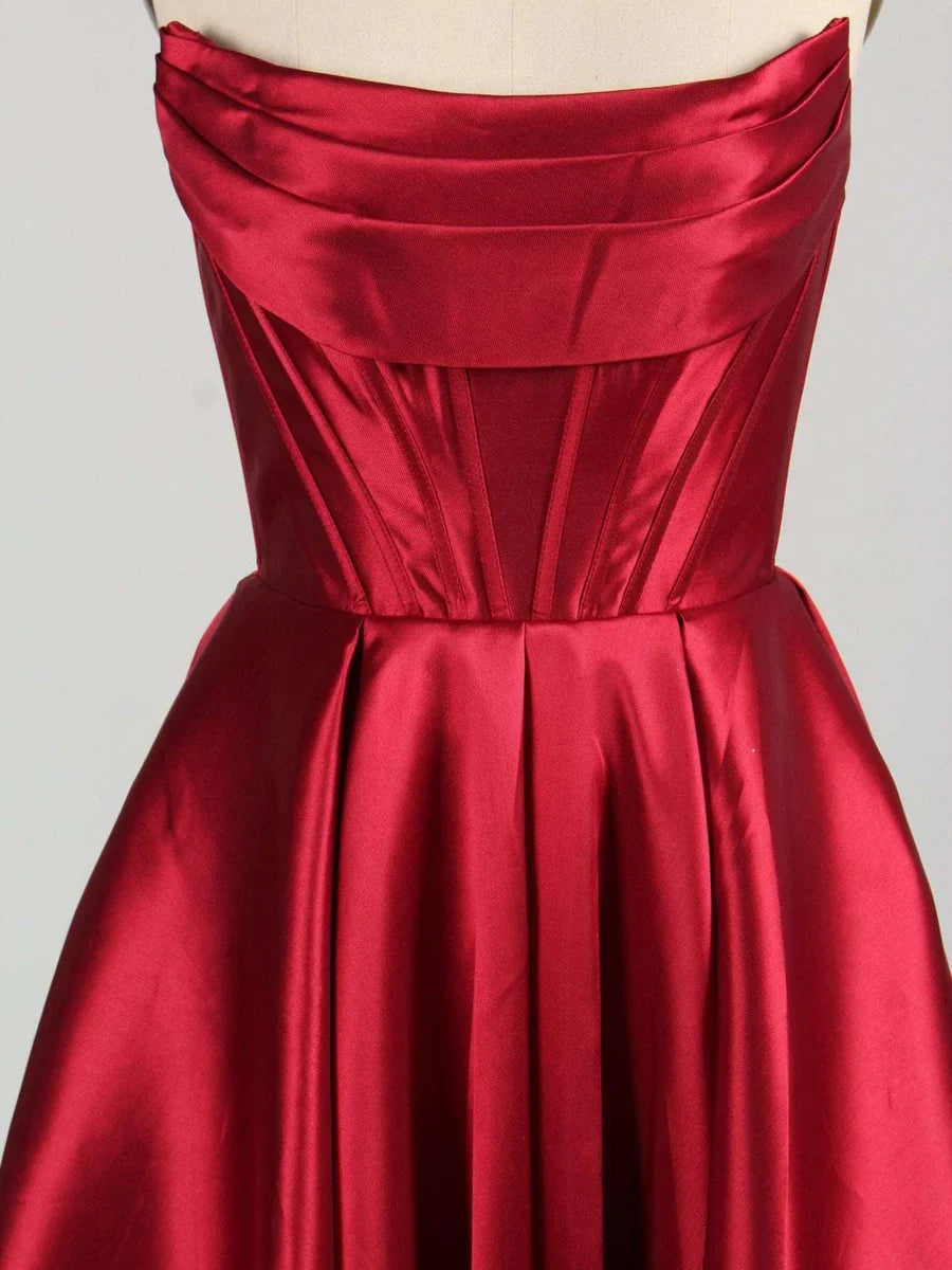 Burgundy strapless satin corset bodice with structured top and pleated full skirt