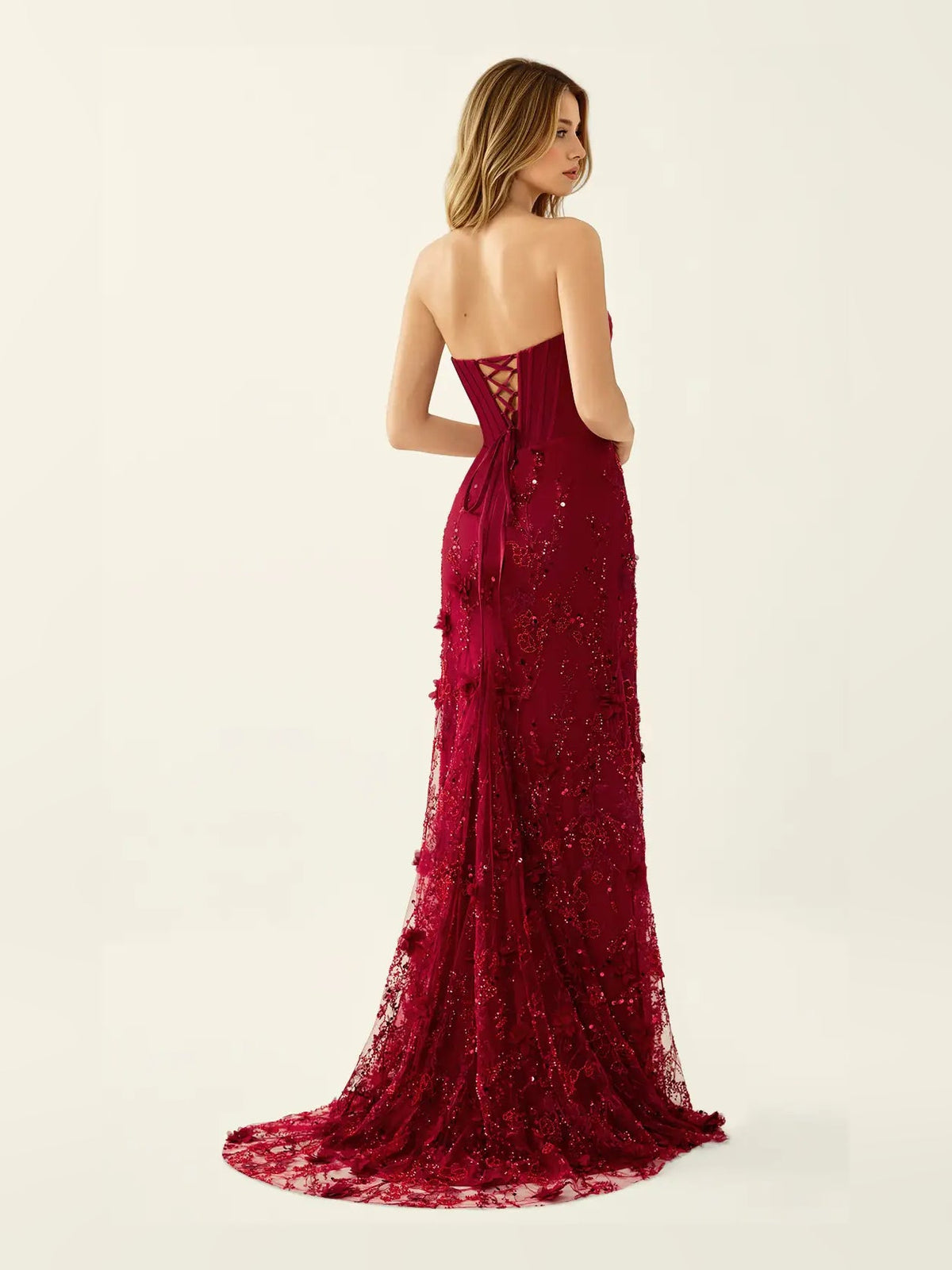 Burgundy corset-style mermaid maxi prom dress with side slit, viewed from back