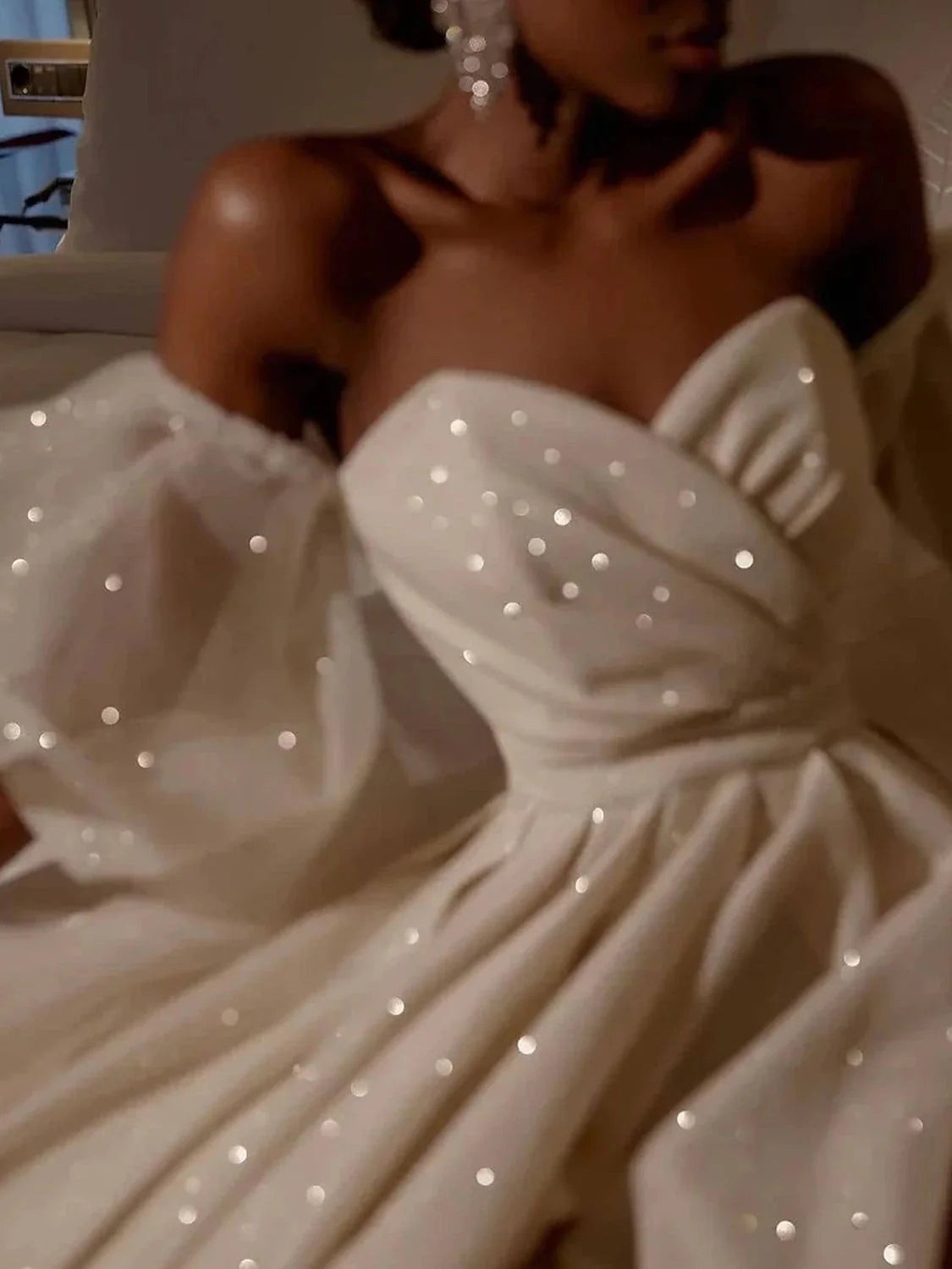 Ivory sweetheart bodice with sparkling beading and draped off-shoulder neckline detail