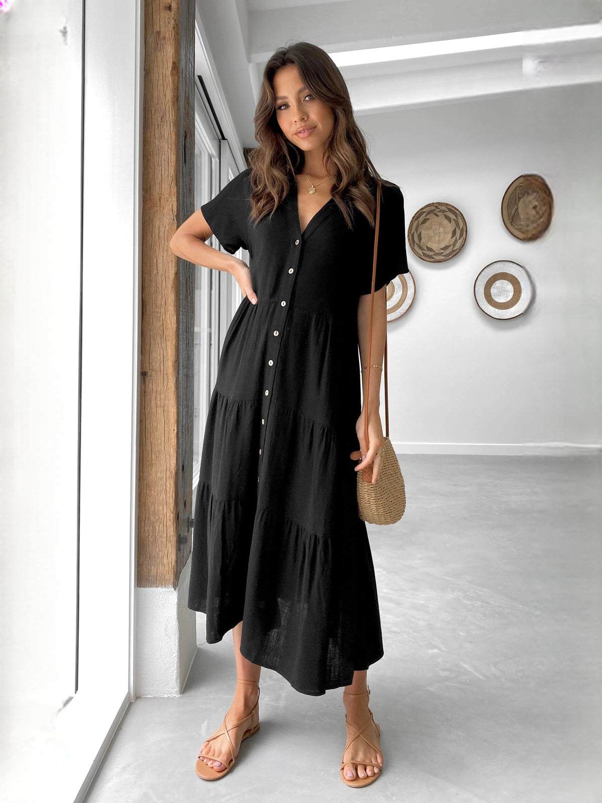Black V-neck midi dress with short sleeves, button front, and tiered swing skirt