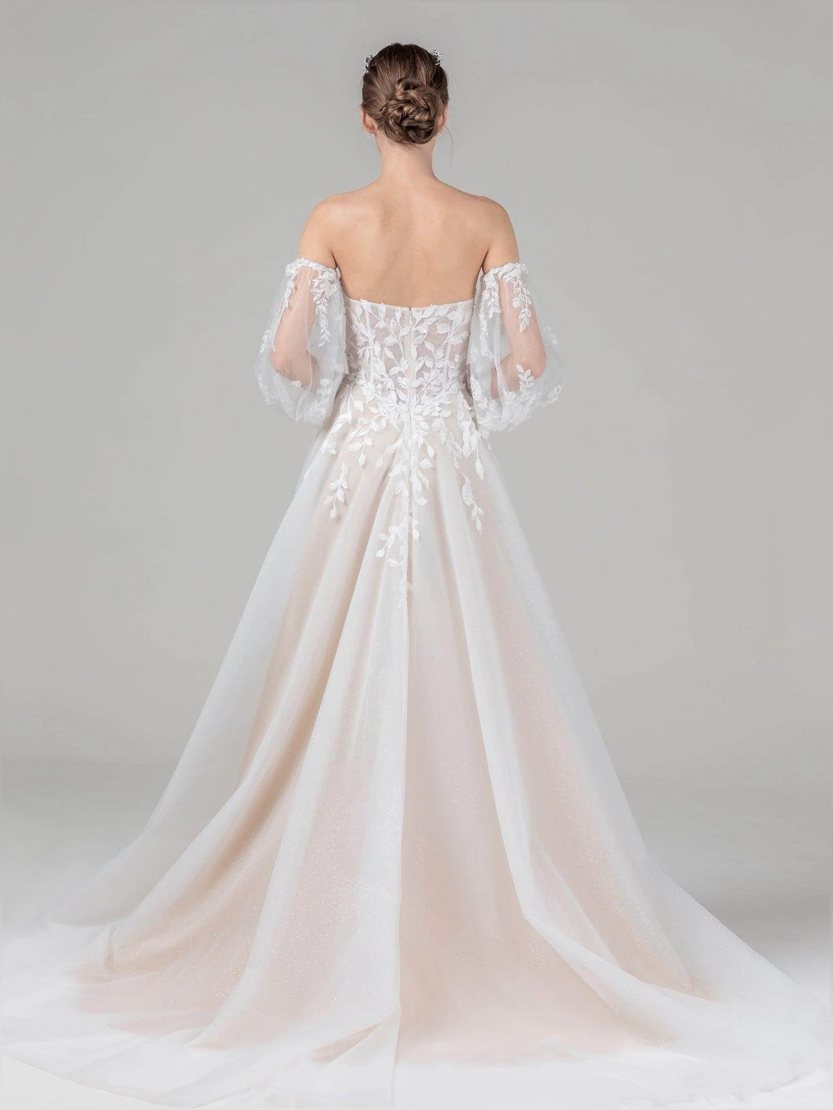 Ivory A-line wedding dress with off-shoulder lace sleeves and tulle skirt, back view