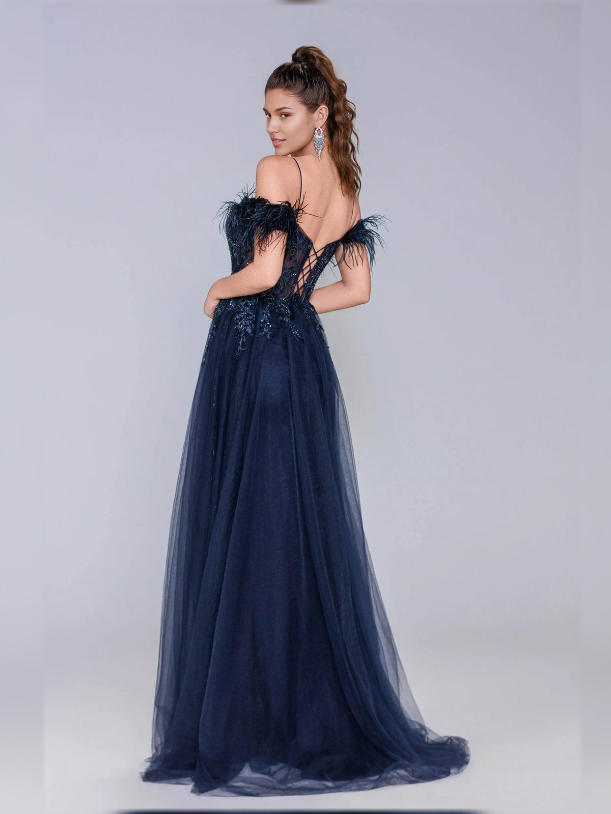 Navy open-back corset formal dress with feather trim and floor-length tulle skirt