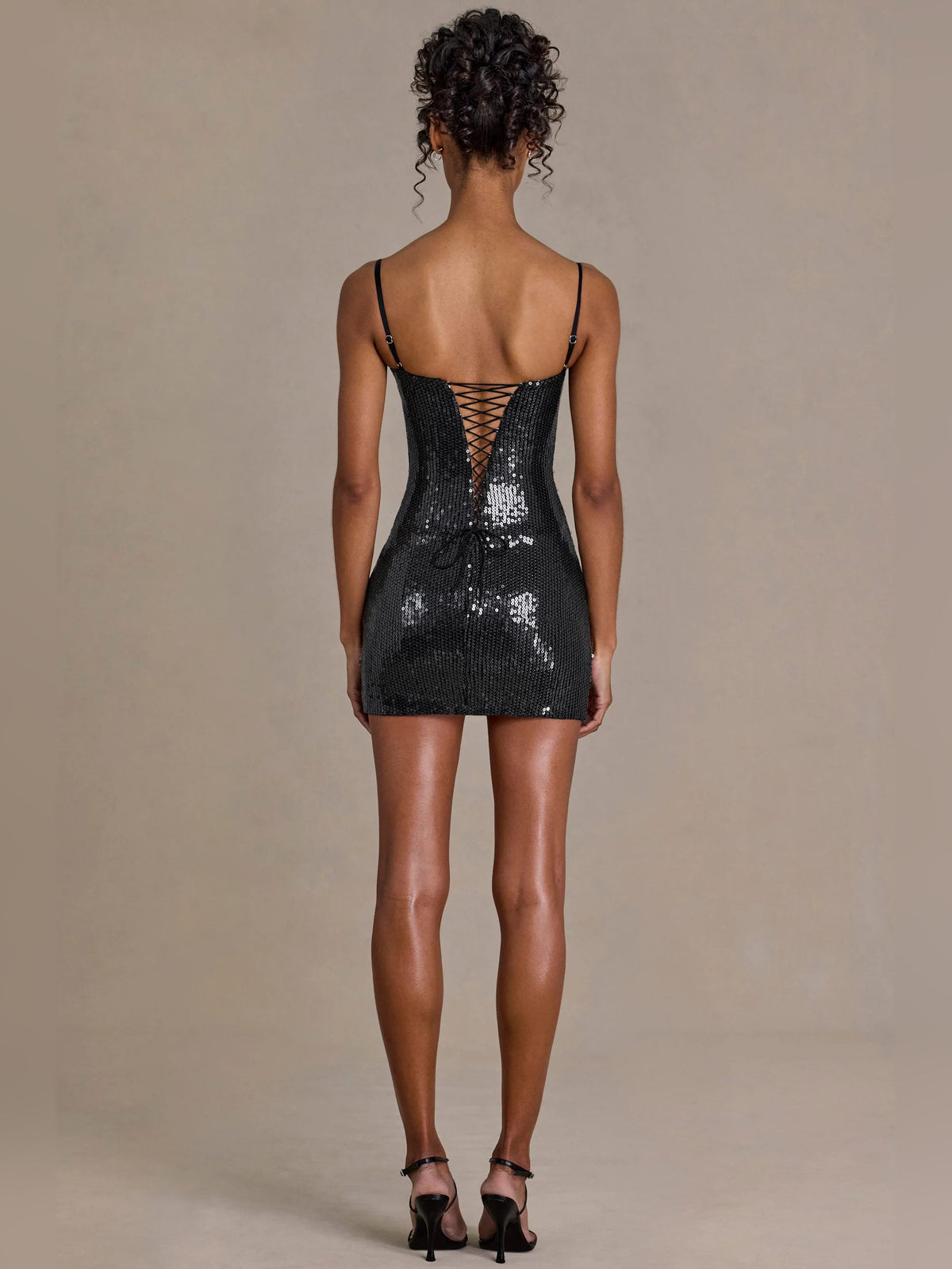 Black sequin corset mini dress with thin straps and low back, rear view