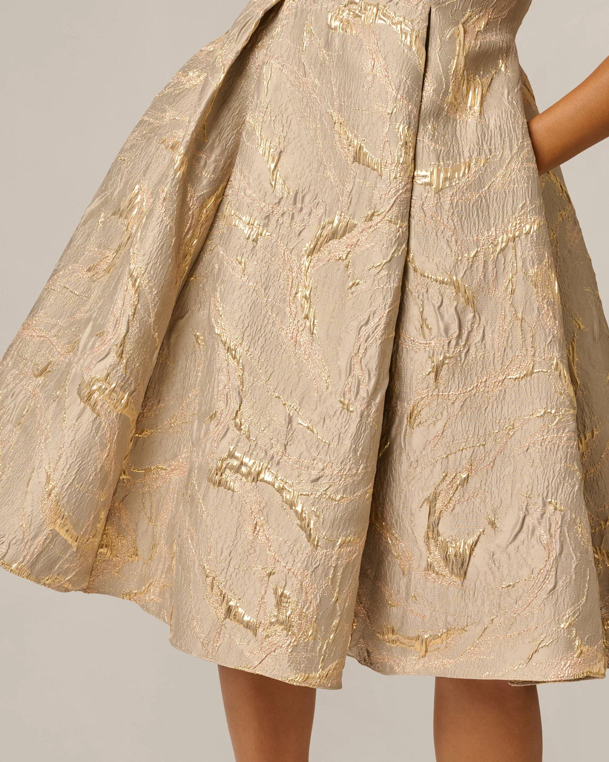 Mink midi fit-and-flare dress skirt close-up, textured gold threads