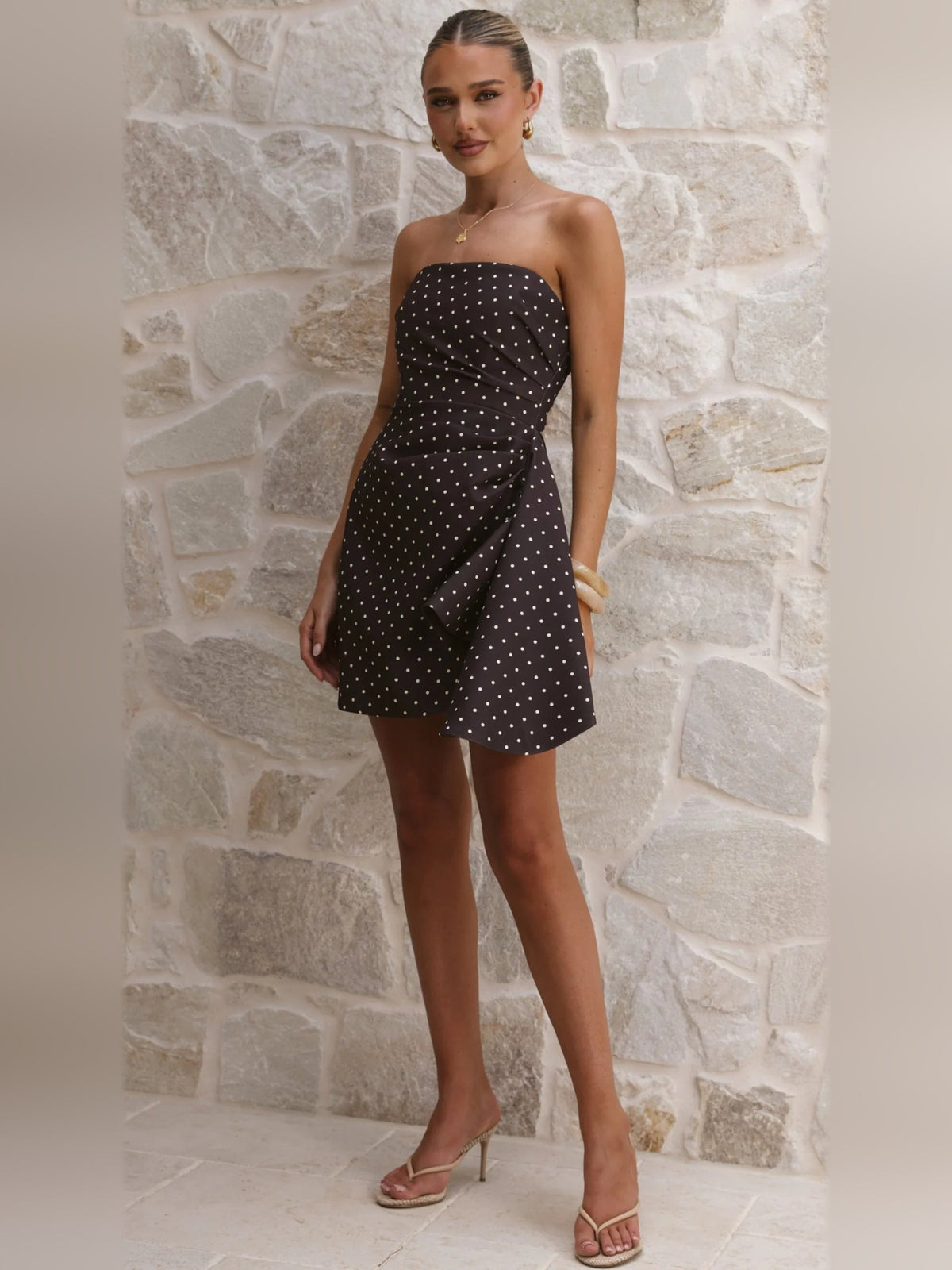 Strapless dark brown mini dress with white polka dots, draped front detail