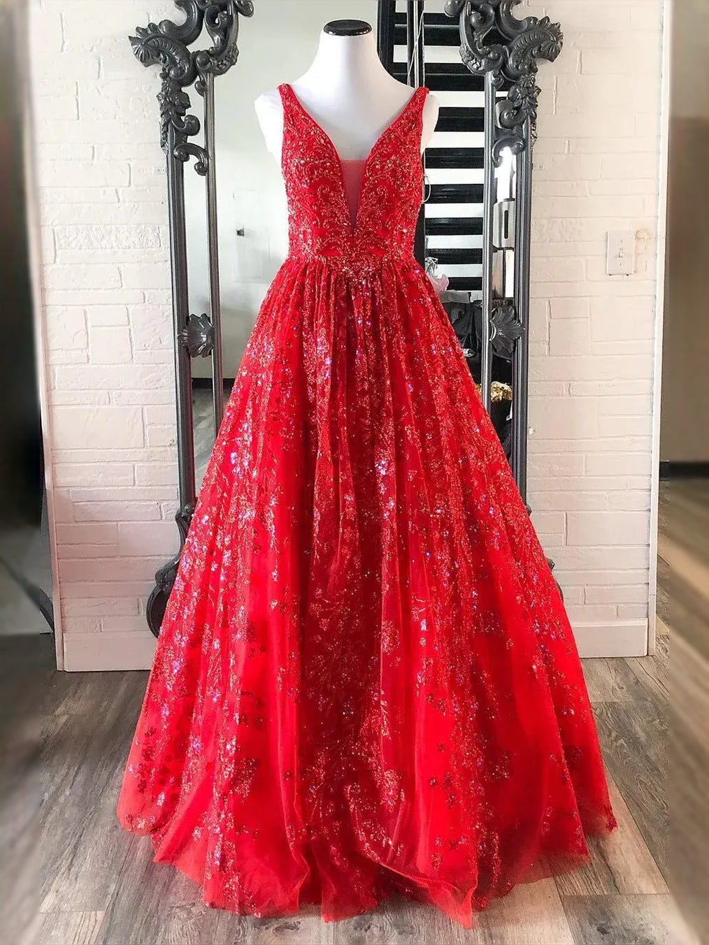 Red sequin floral tulle A-line prom dress on mannequin, V-neck open-back