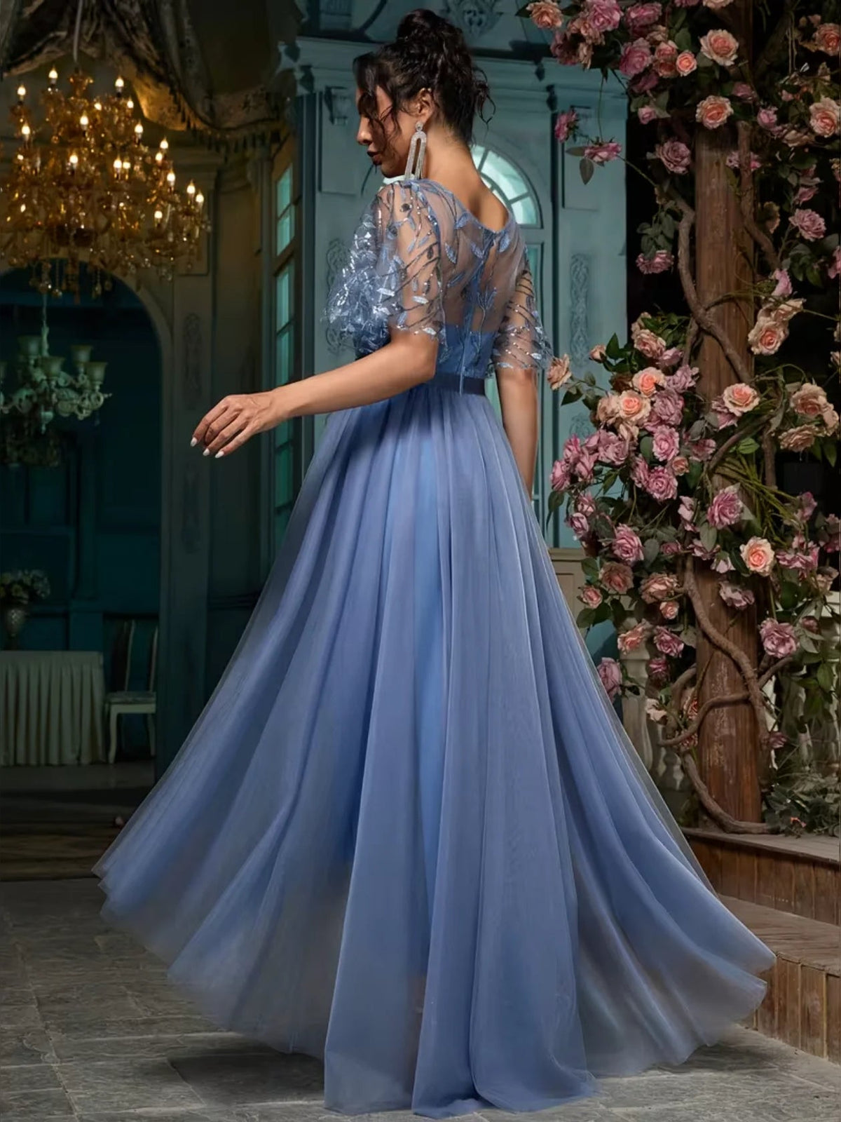 Slate blue A-line maxi prom dress with embroidered short sleeves and flowing tiered skirt.