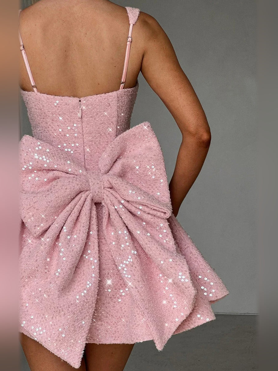 Blush pink sequined mini dress with square neck and large bow at back waist