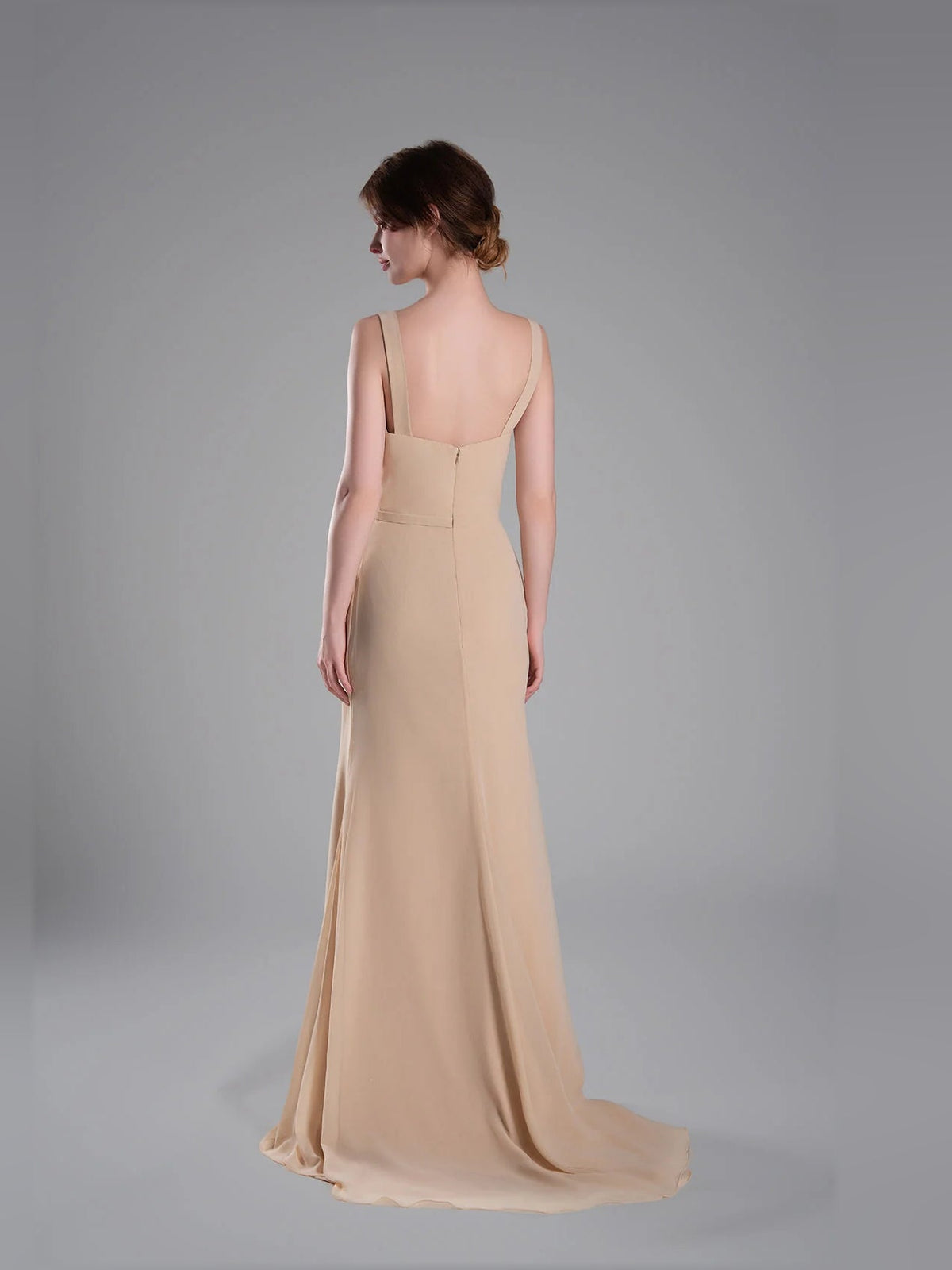 Back view of beige cowl-neck sheath maxi dress with narrow straps and long skirt
