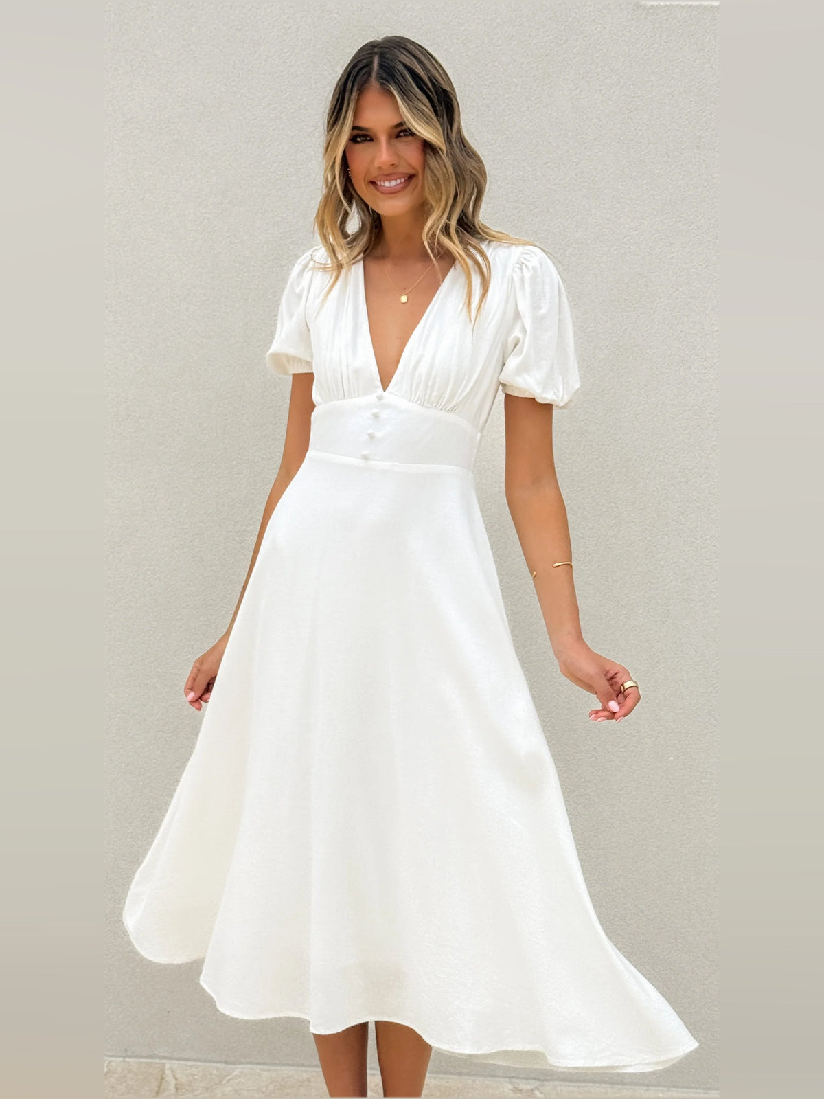White V-neck midi dress with puff sleeves and pleated, twirled skirt hem
