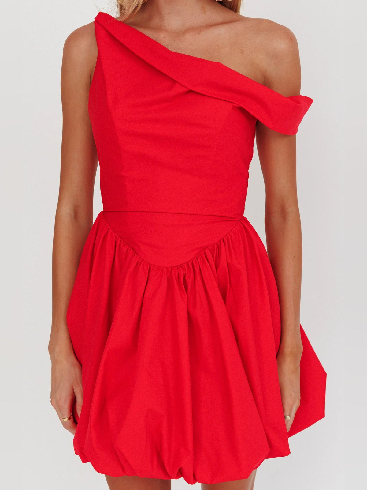 Red one-shoulder mini homecoming dress with diagonal neckline and ruched waist