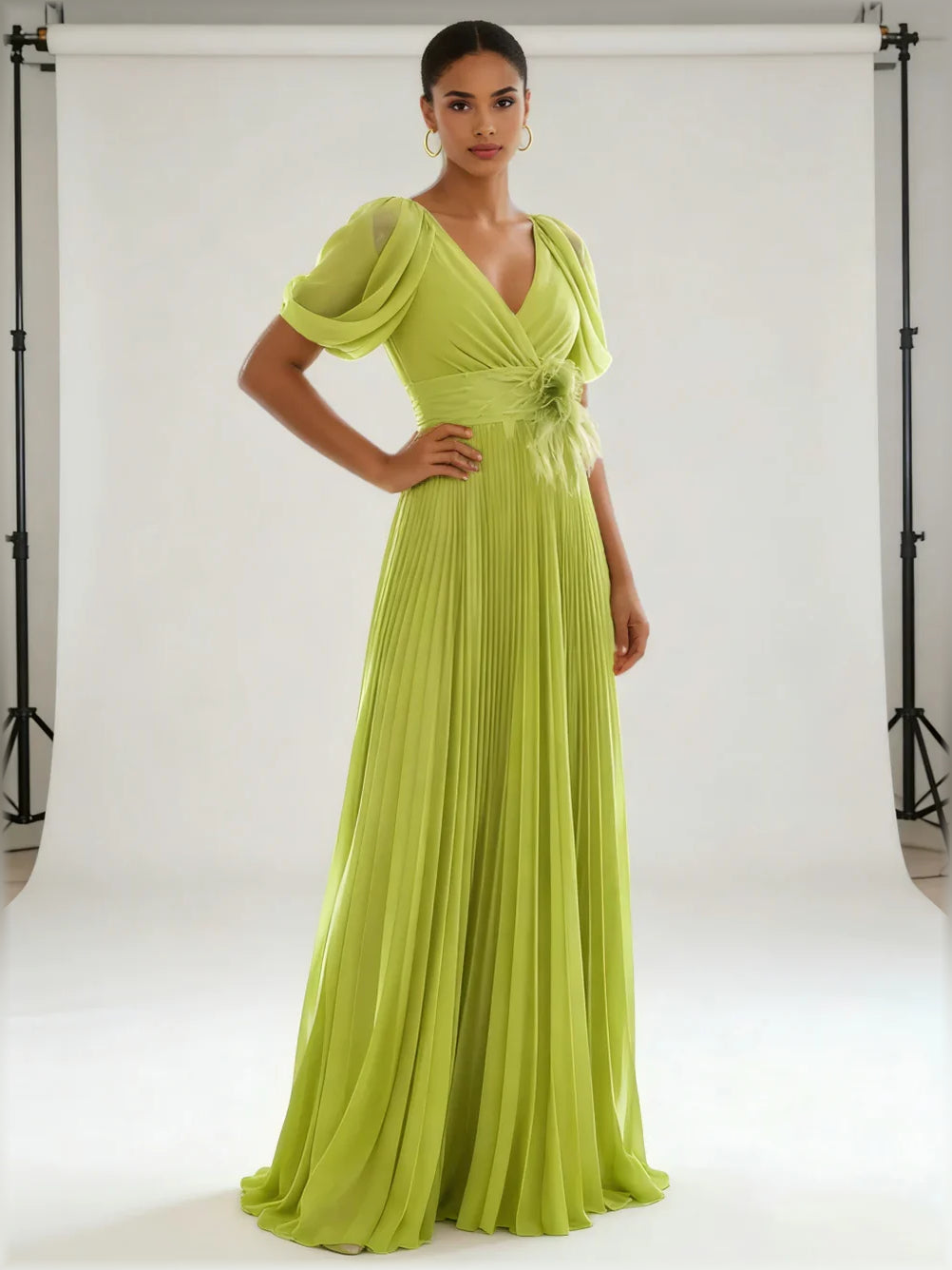 Olive green V-neck formal dress with short puff sleeves and pleated floor-length silhouette