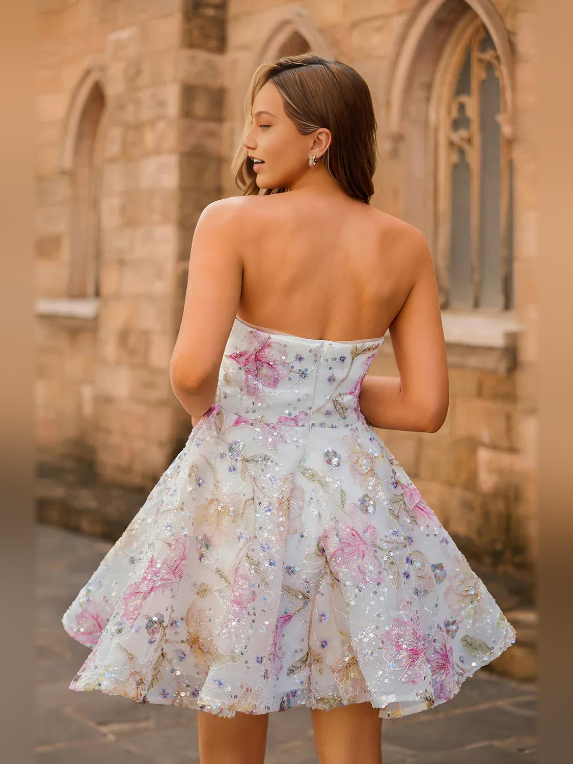 Low-back strapless mini tulle dress with floral sequin embroidery and pink accents