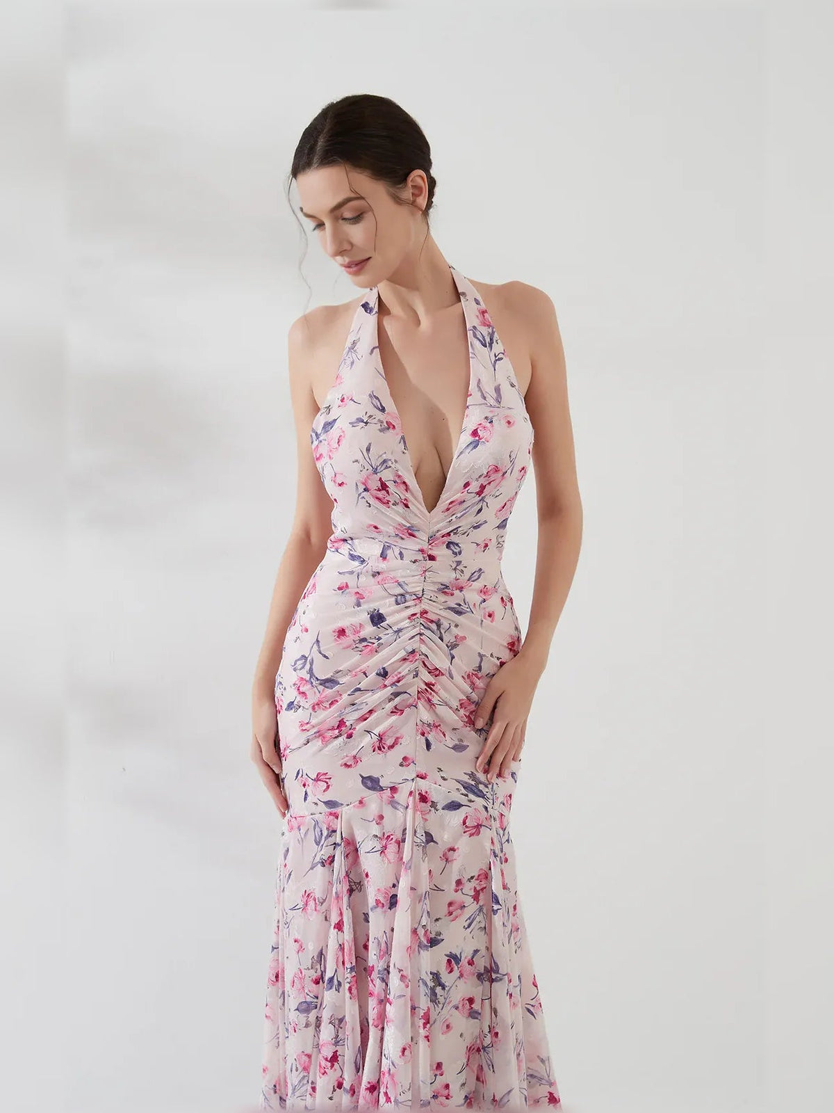 Floral ruched halter dress with deep V neckline and tiered floor hem