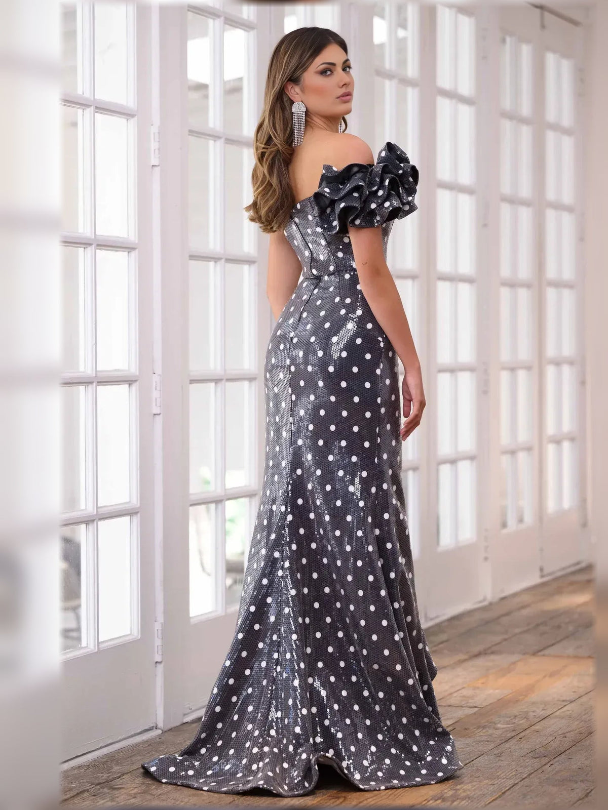 Black polka dot one-shoulder gown with ruffled shoulder bow and flowing skirt