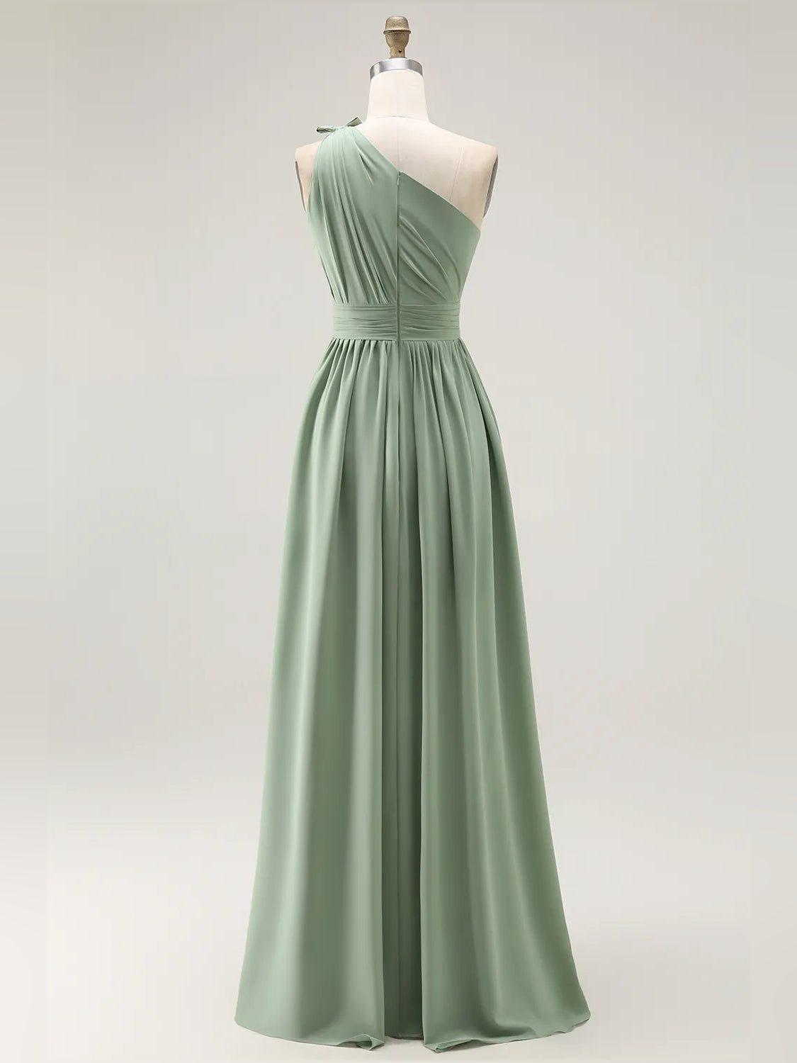 Dusty sage one-shoulder chiffon bridesmaid dress on mannequin, draped skirt and slit