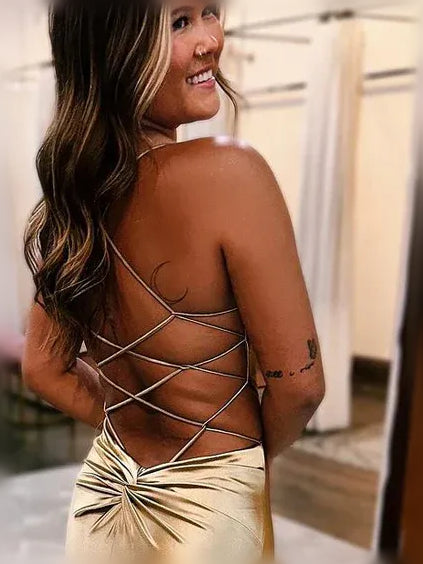 Gold spaghetti-strap formal dress with crisscross open-back straps and ruched front