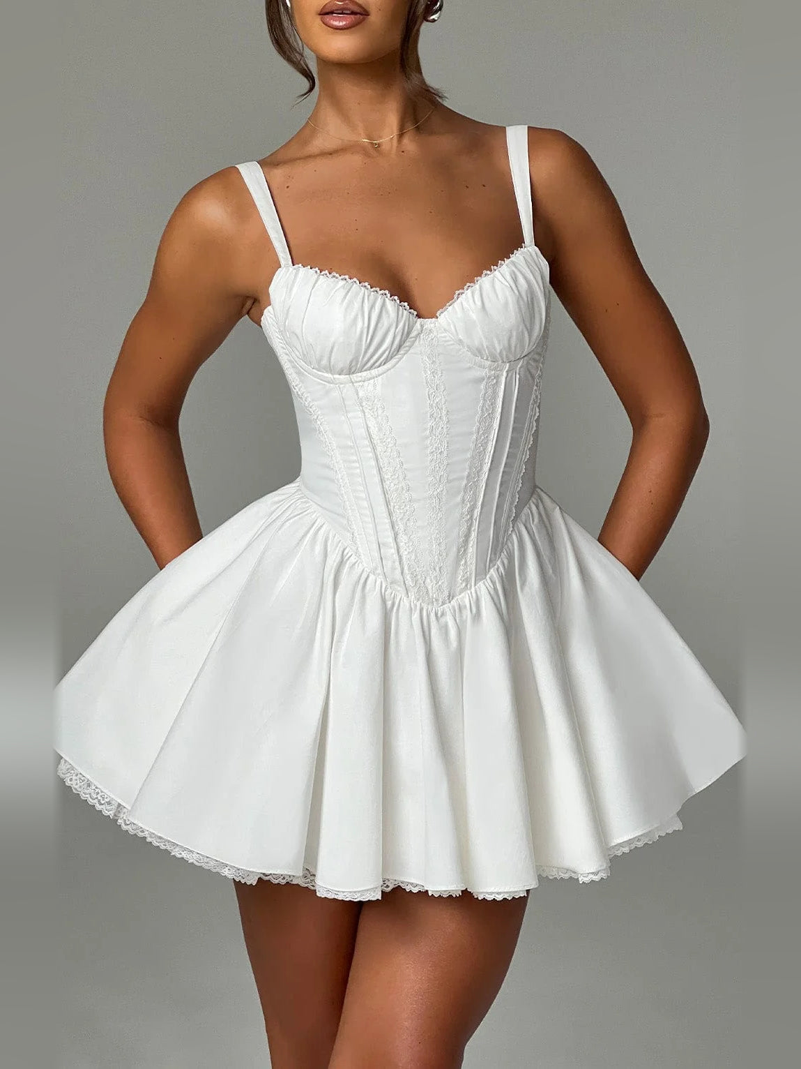 White mini homecoming dress with sweetheart bodice, corset-style seams, flared skirt