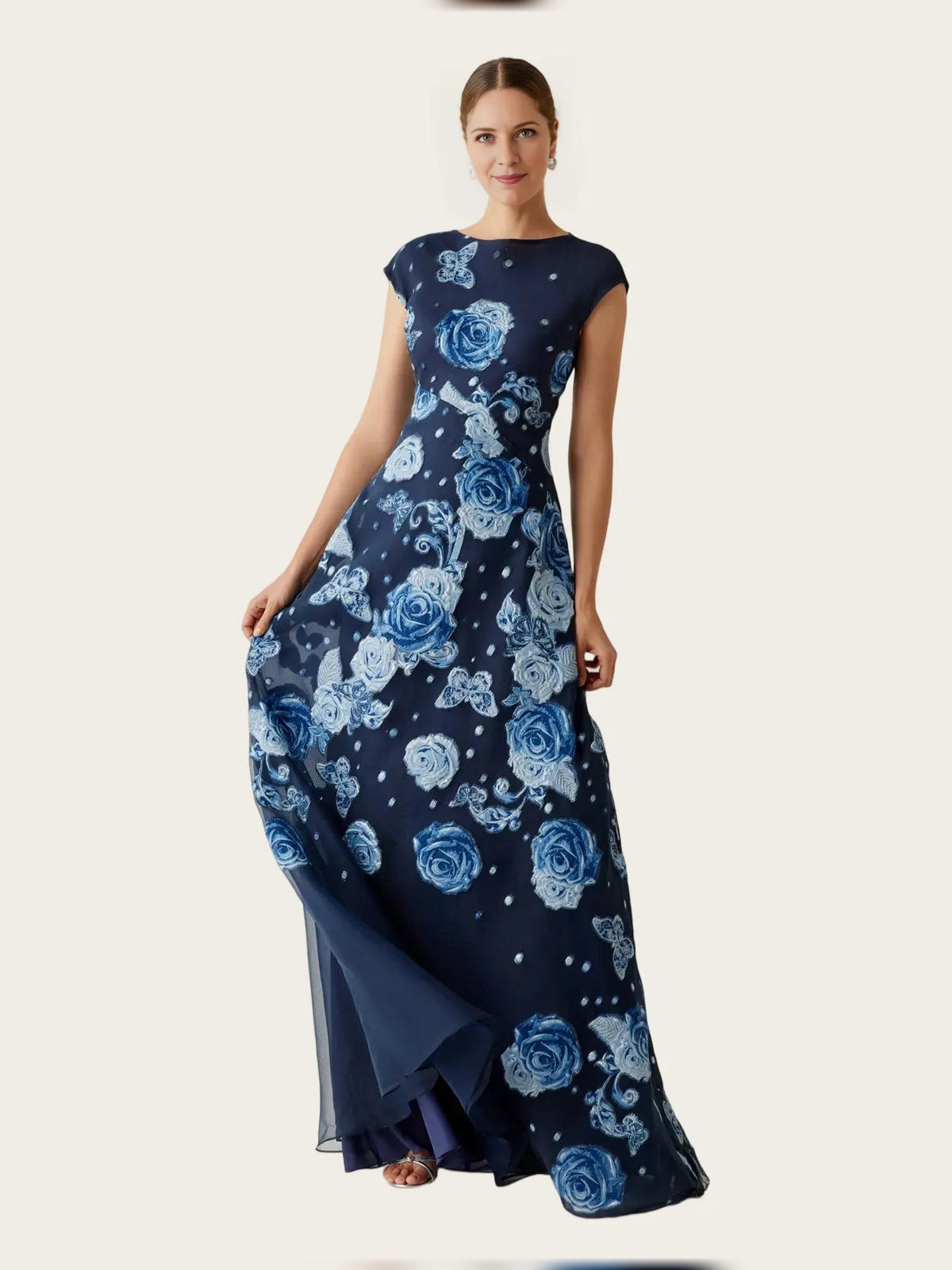 Navy A-line maxi dress with round neck, cap sleeves, blue rose floral print, layered hem