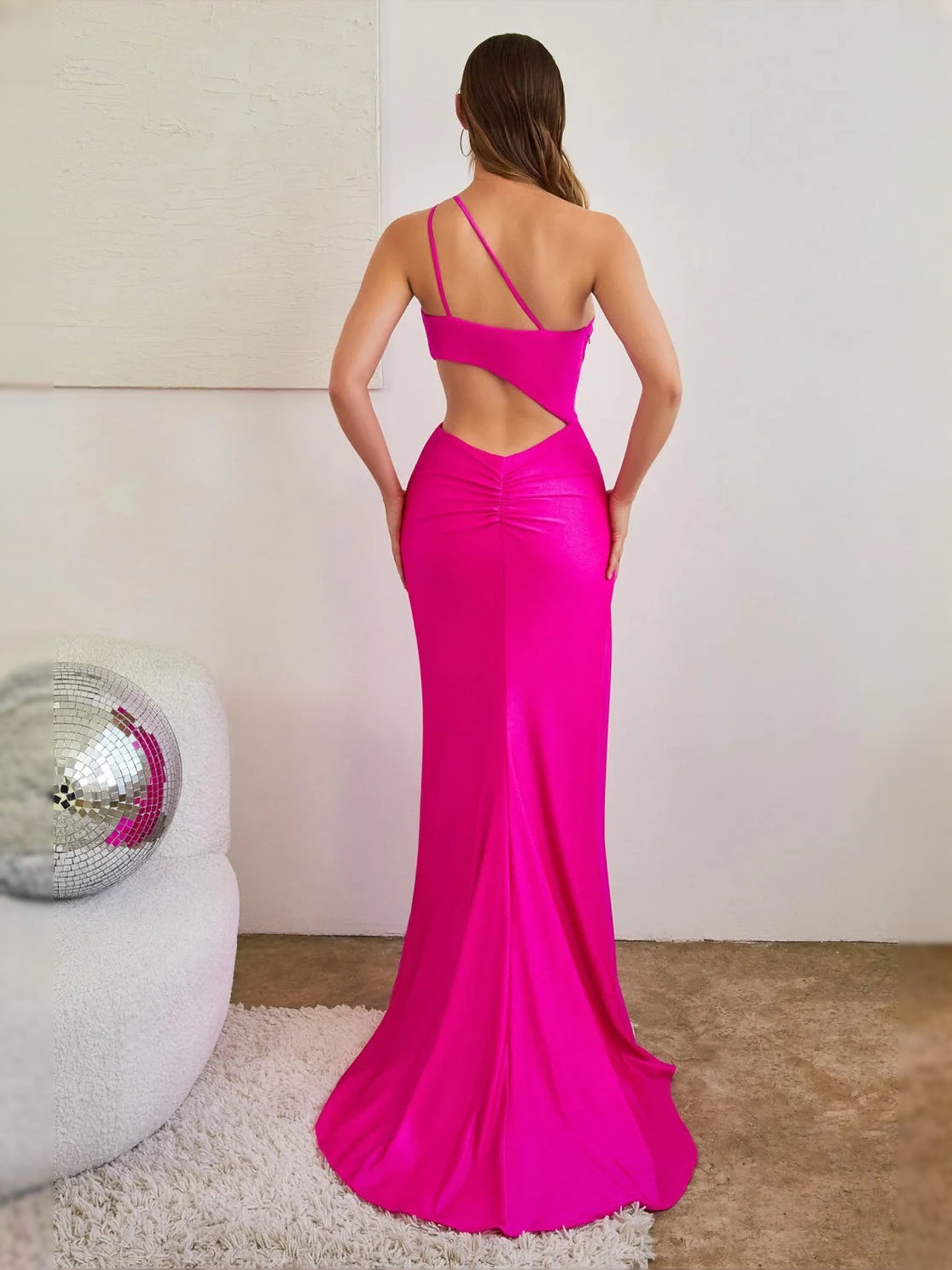 Magenta backless mermaid prom dress with cut-out strap detail and floor-length flare