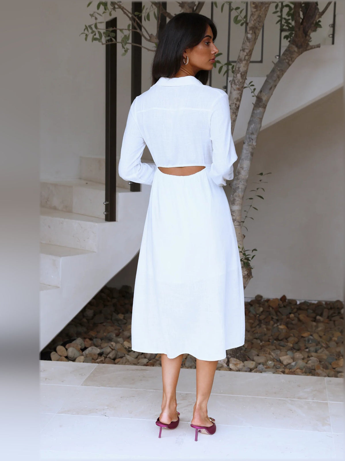 White midi formal dress with long sleeves and back waist cutout.