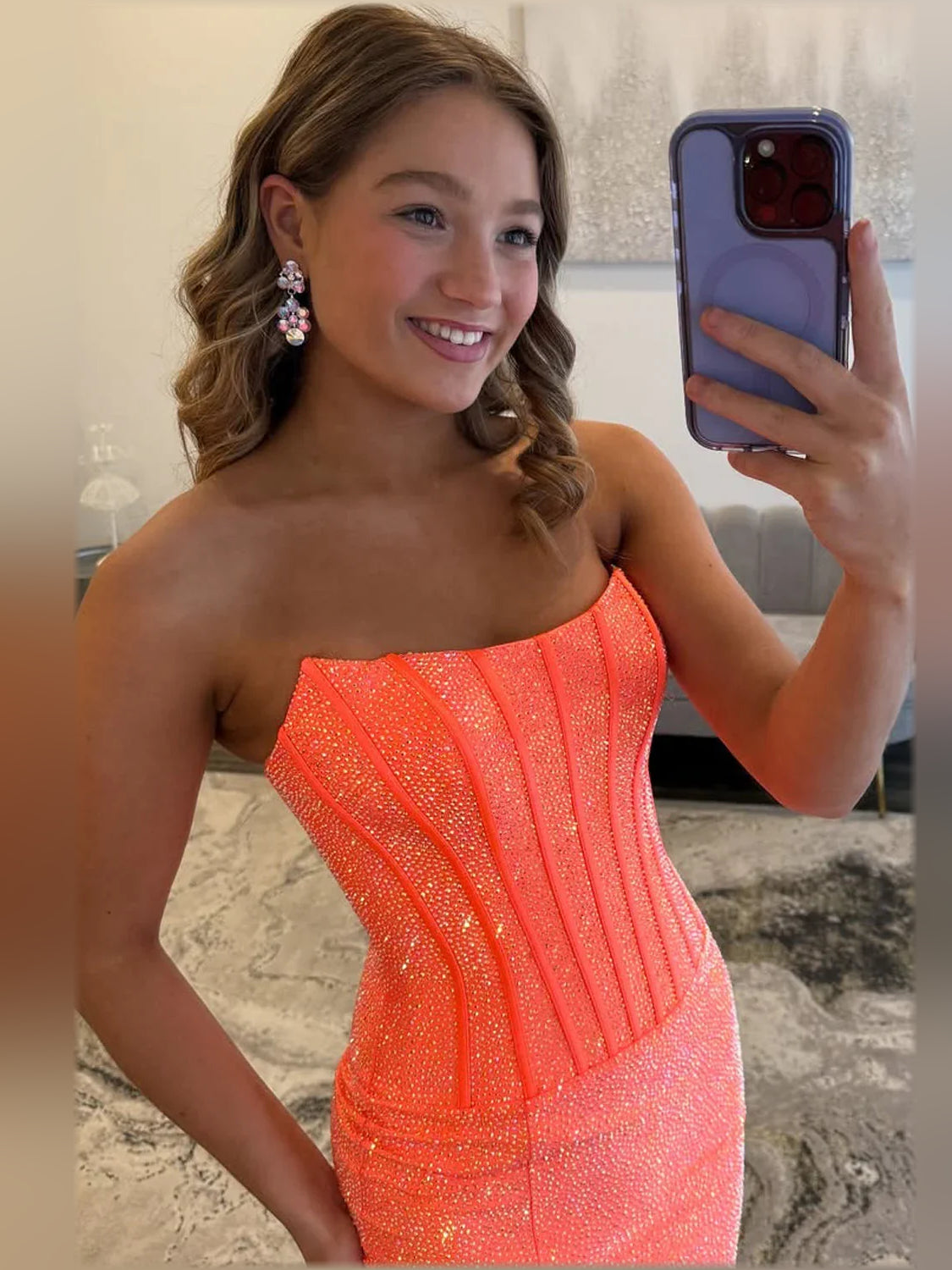 Orange strapless corset bodice formal dress with sparkly texture, close-up view