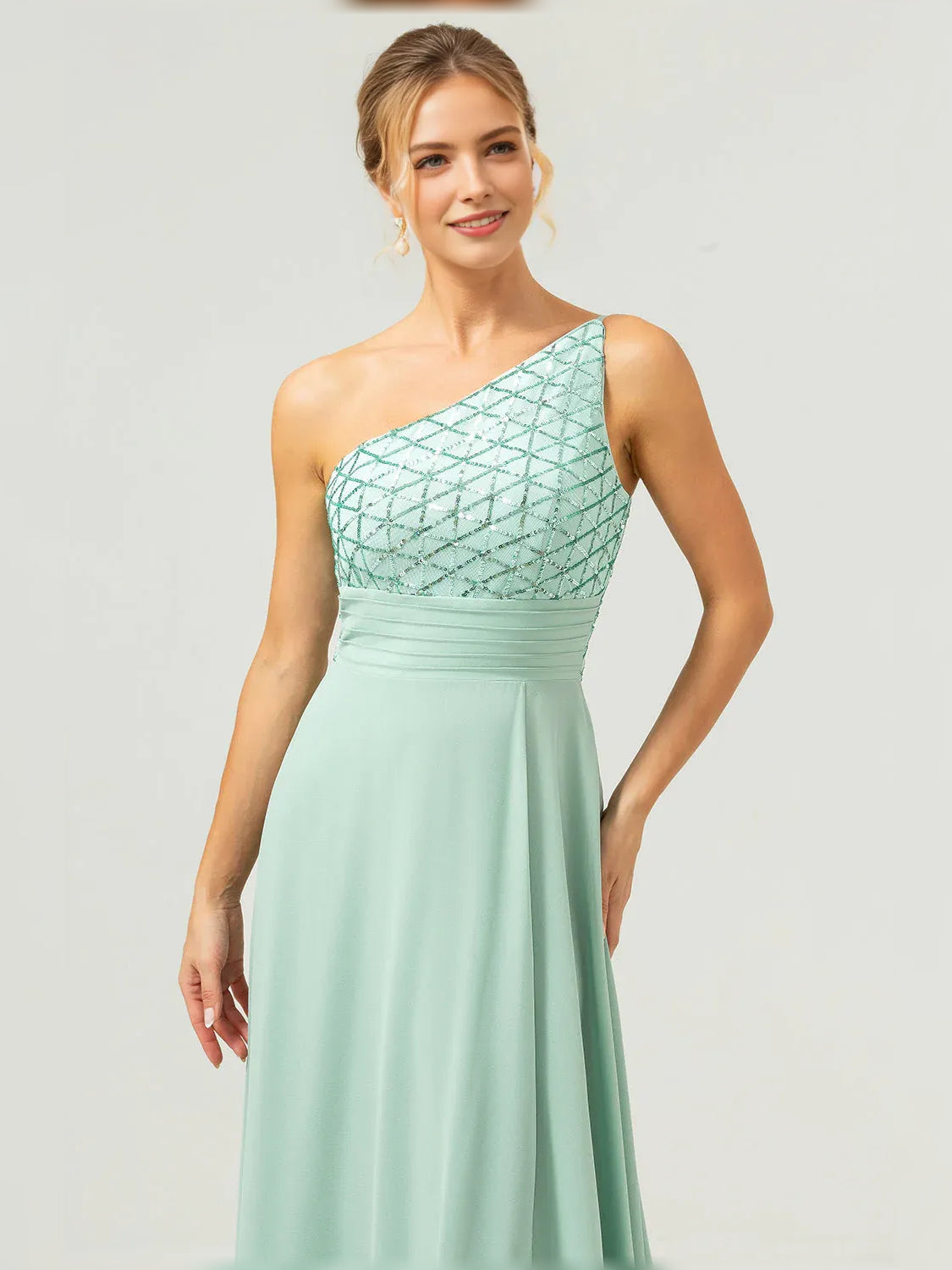 Mint green one-shoulder formal dress with beaded geometric bodice and pleated waist