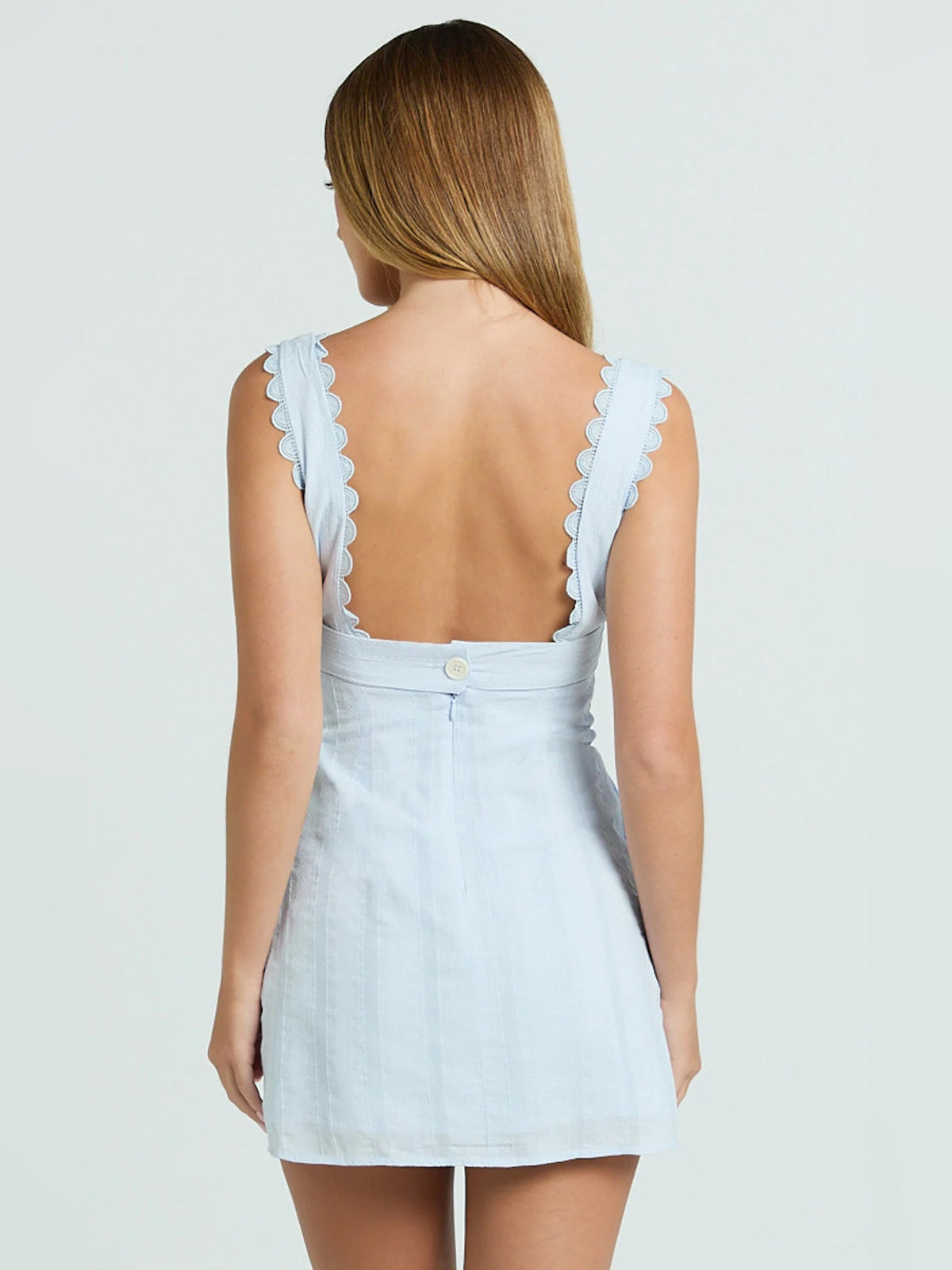 Light blue A-line mini dress back view with ruffled cap straps and seam detail