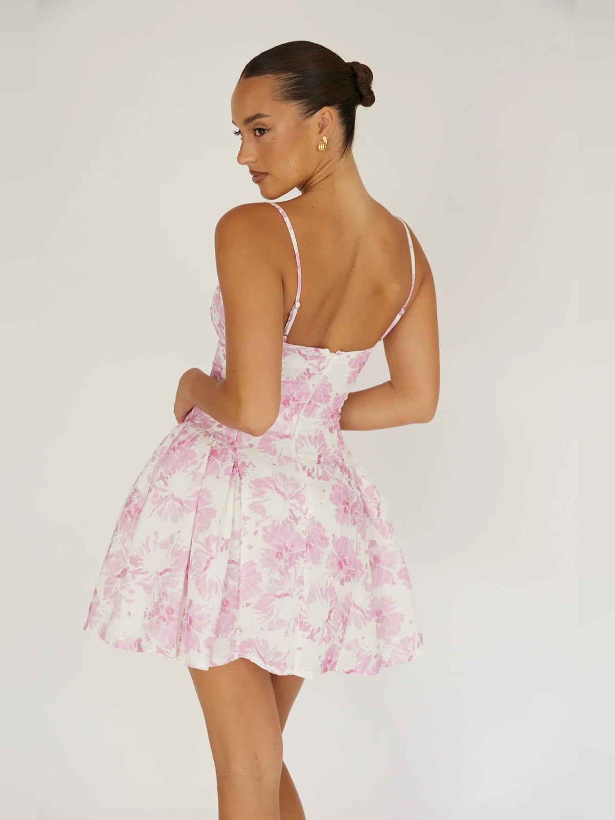 Pink floral mini dress back view with spaghetti straps and flared skirt