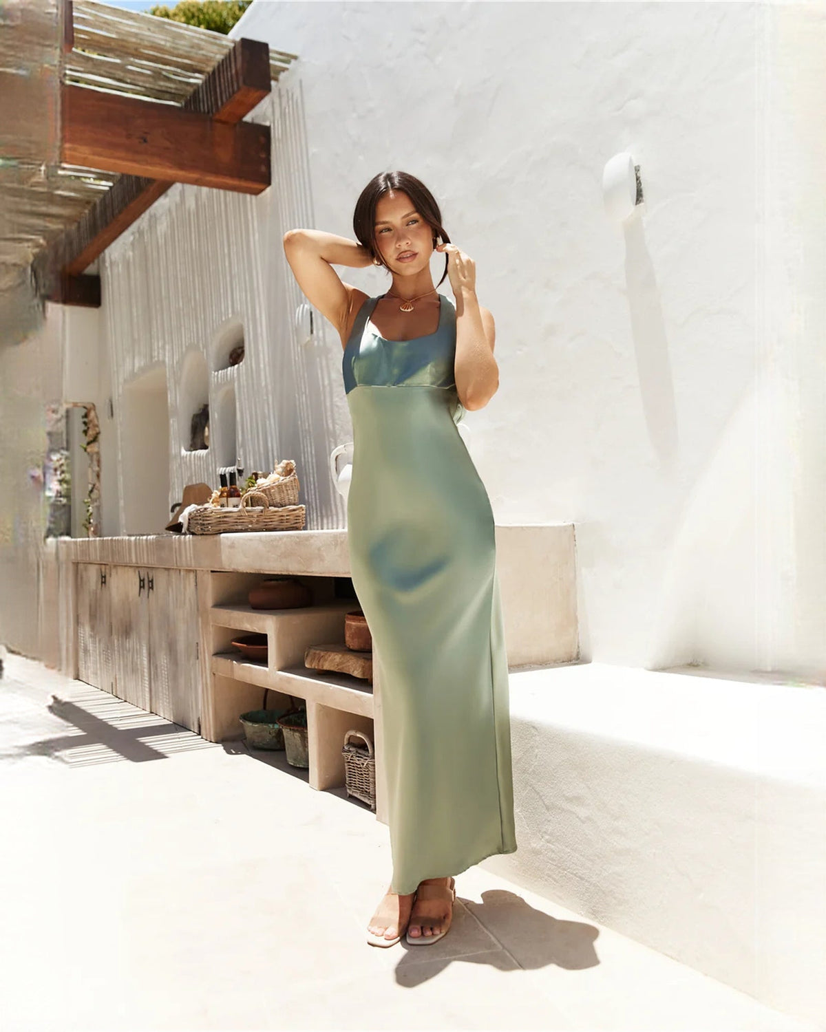 Sage green satin A-line midi dress with sleeveless scoop neckline and fitted bodice