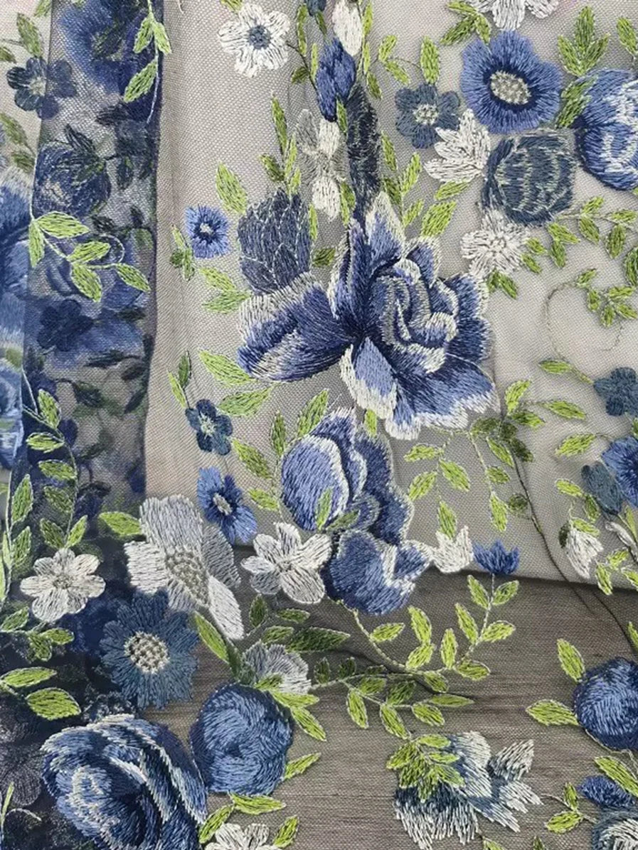 Dusty blue and white floral embroidery on sheer tulle fabric