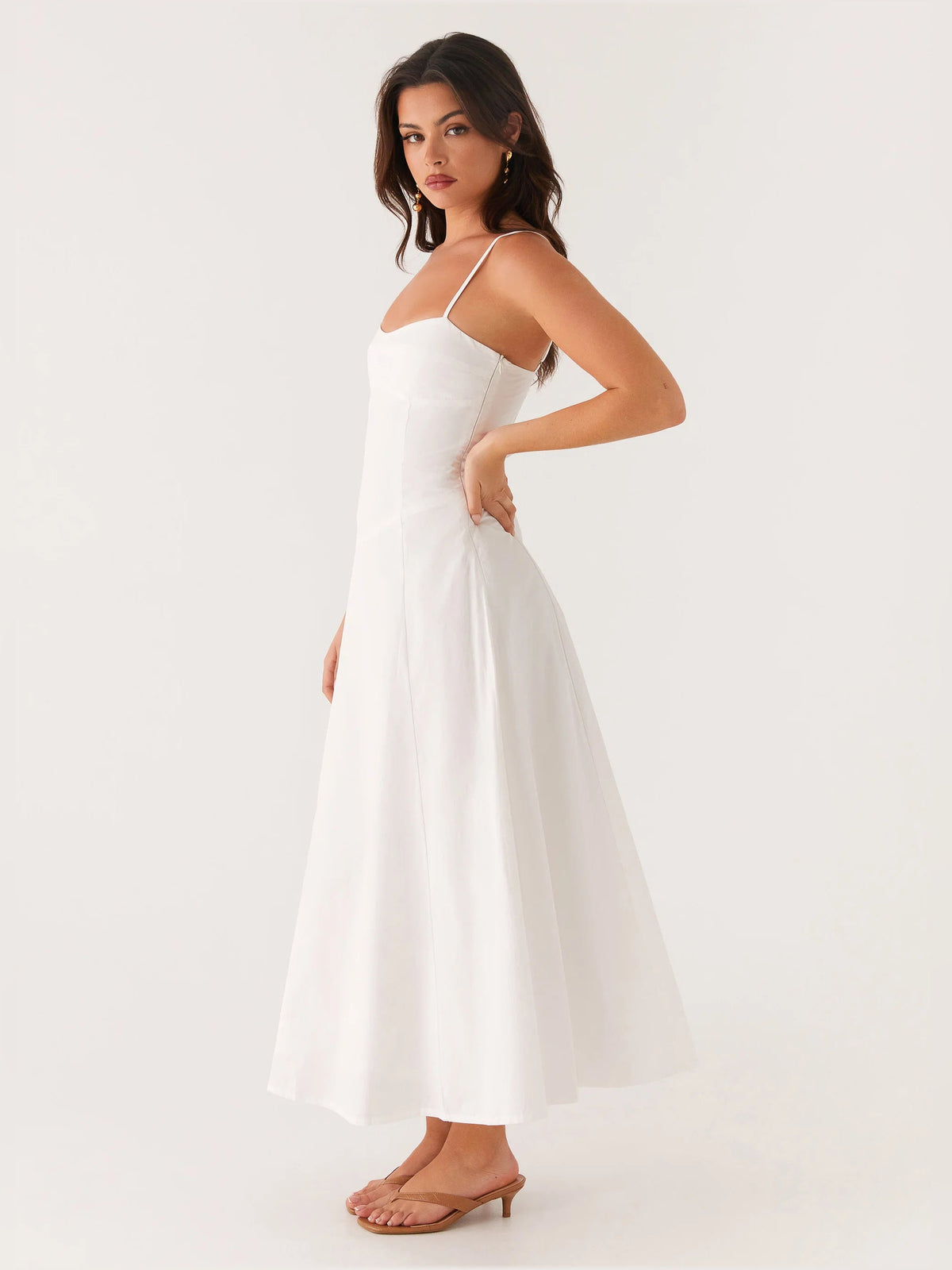 White midi formal dress, side view with spaghetti straps and flared hem