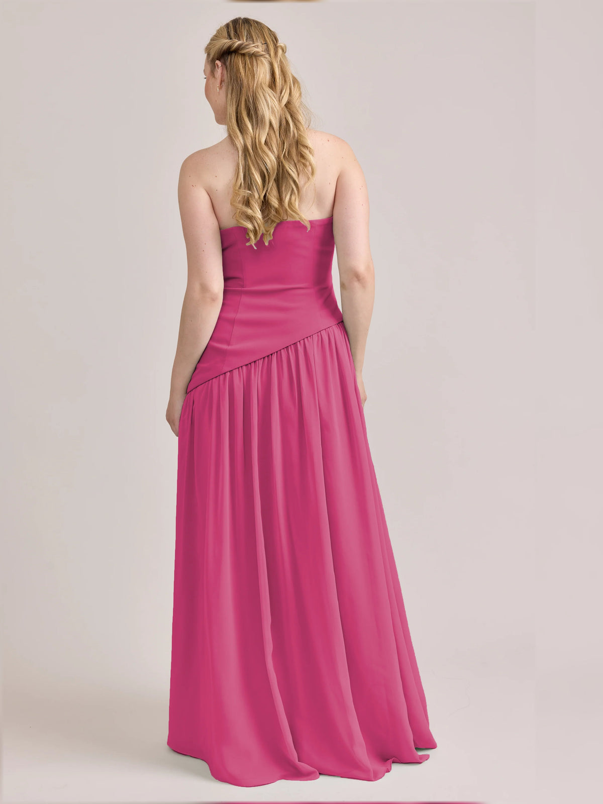 Hot pink strapless A-line maxi chiffon dress, back view, flowing pleated skirt
