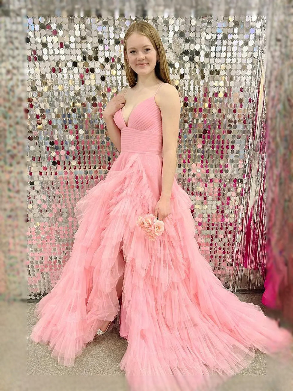 Pink V-neck A-line maxi tulle prom dress with layered ruffle tiers and flower waist detail