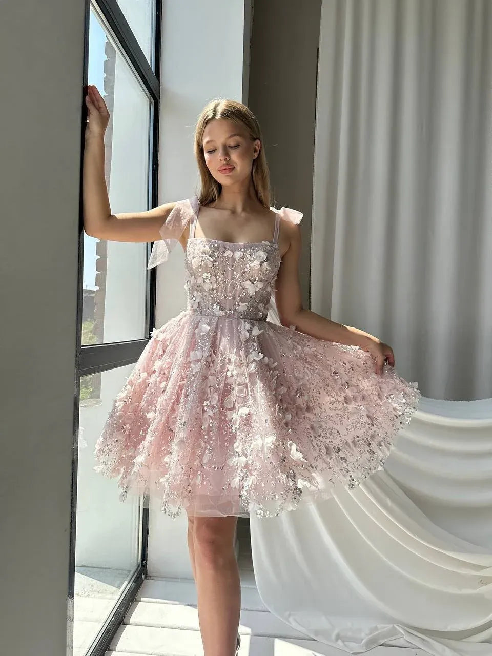 Blush pink off-shoulder corset mini tulle dress with floral appliques and large ribbon bows